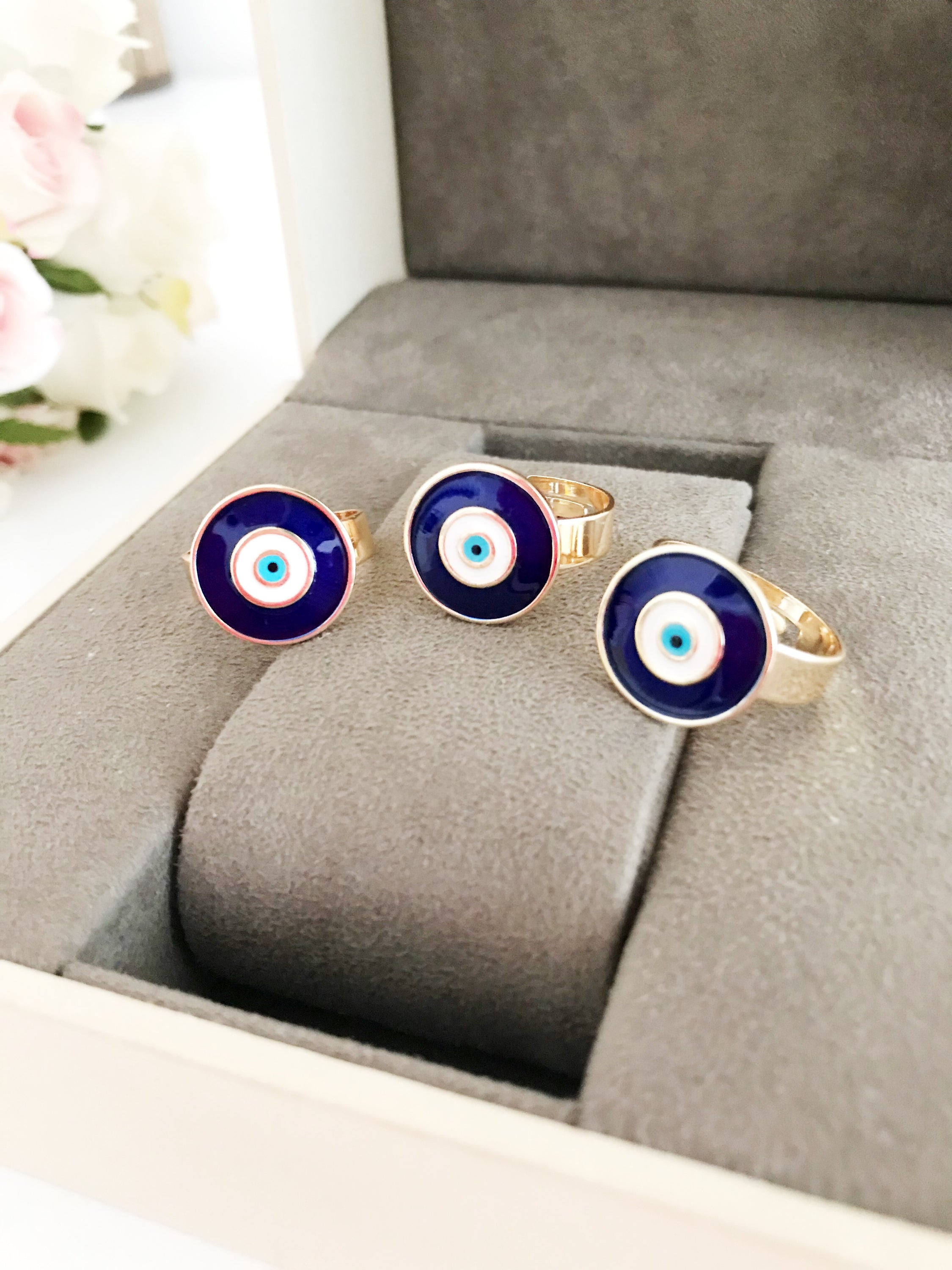 Adjustable blue evil eye ring featuring a round eye design, symbolizing protection and good luck, crafted for comfort and style.