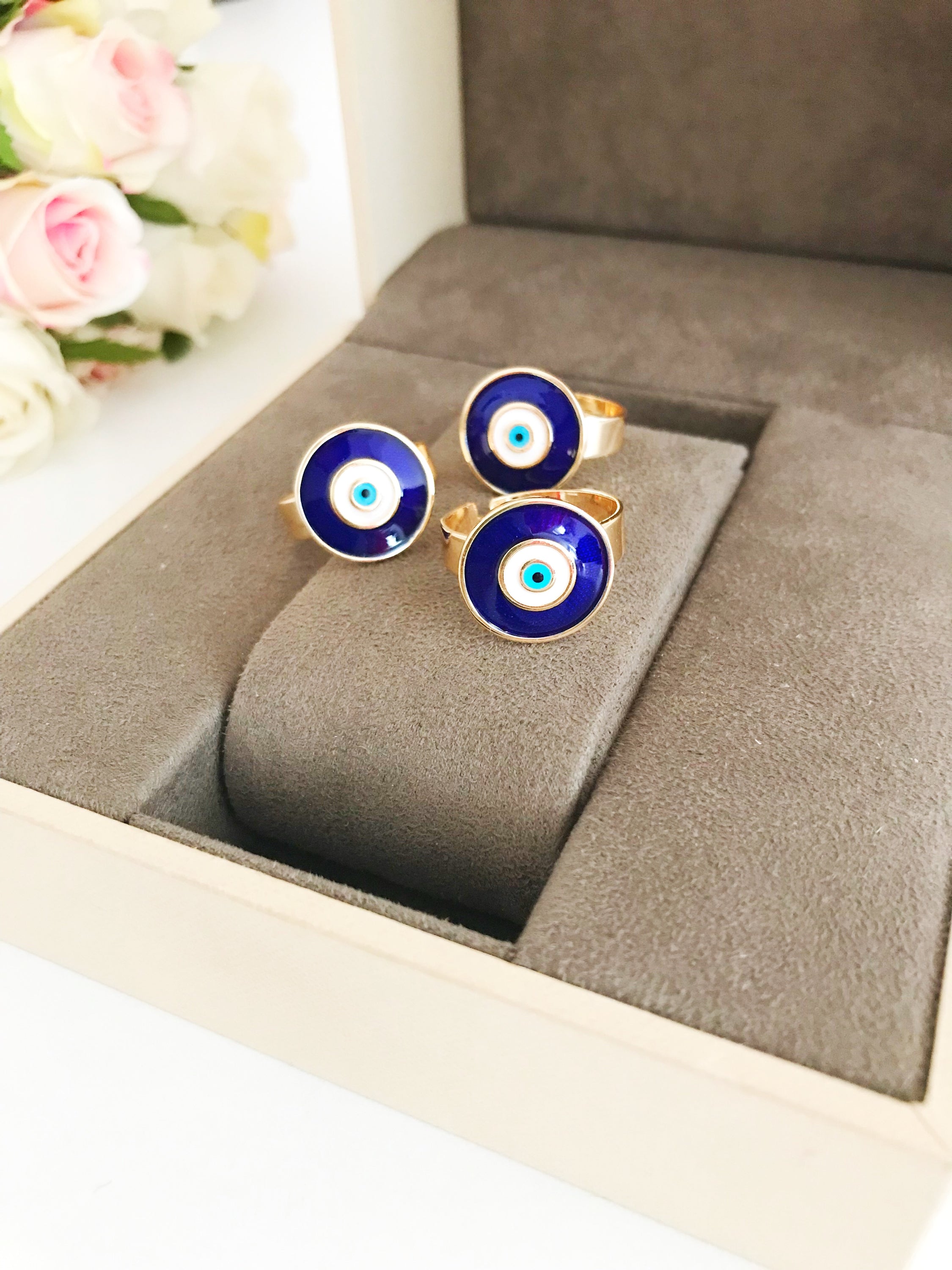 Adjustable blue evil eye ring featuring a round eye design, symbolizing protection and good luck, crafted for comfort and style.