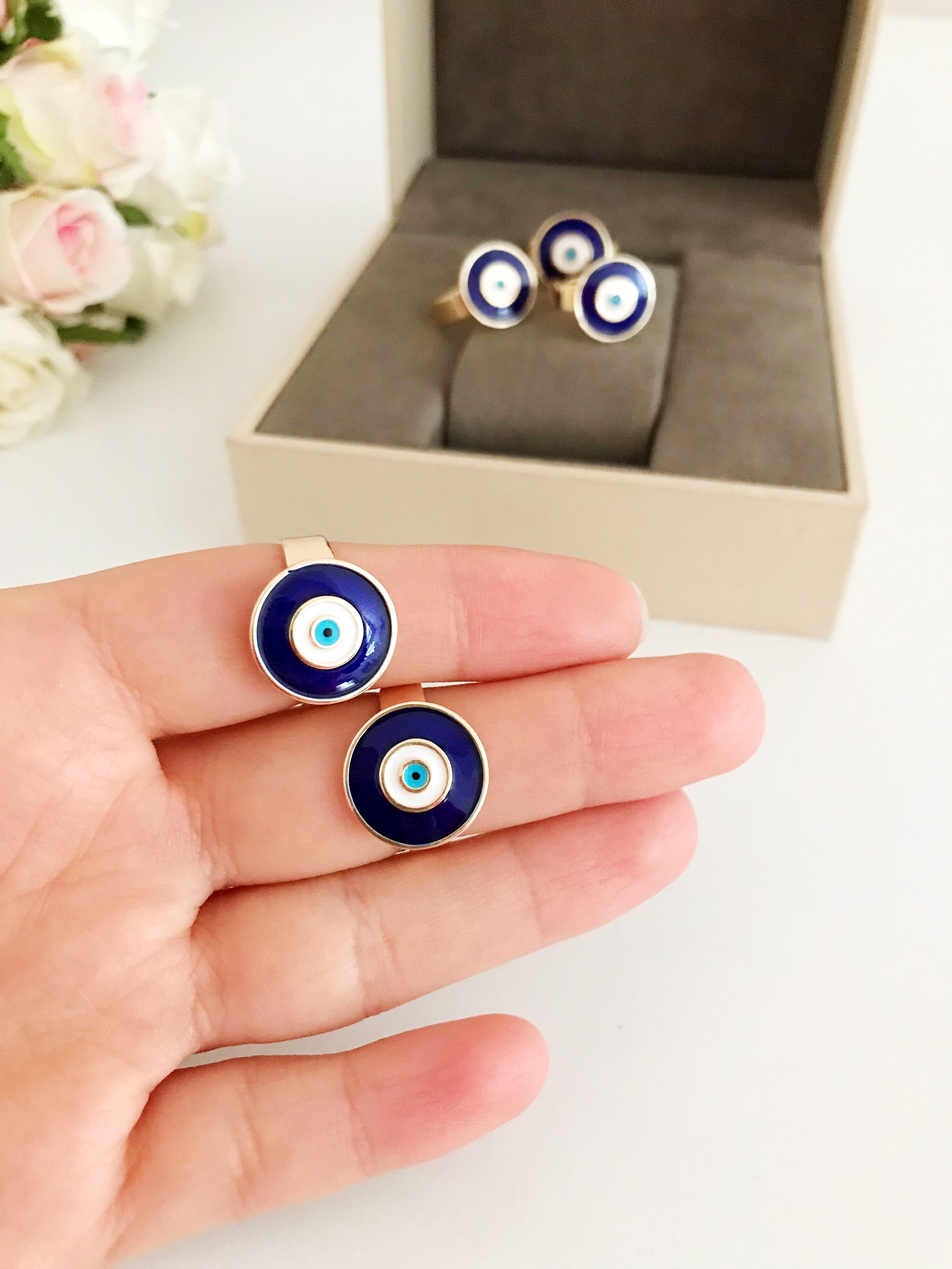 Adjustable blue evil eye ring featuring a round eye design, symbolizing protection and good luck, crafted for comfort and style.