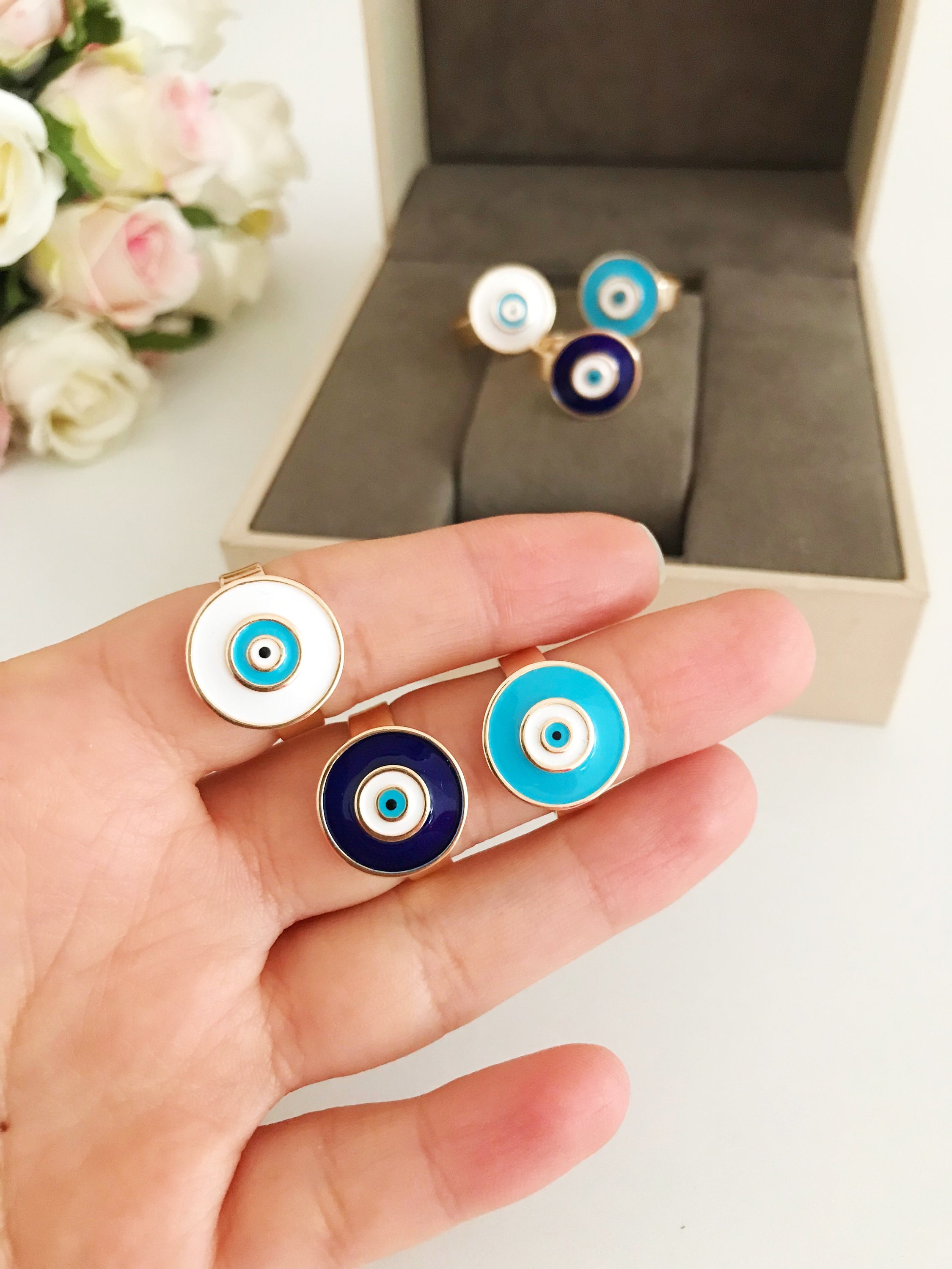 Adjustable blue evil eye ring featuring a round eye design, symbolizing protection and good luck, crafted for comfort and style.