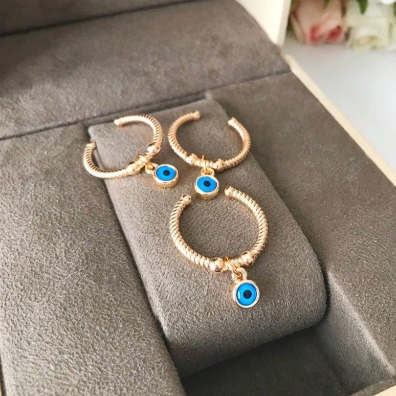 Adjustable Dangle Evil Eye Ring featuring a blue evil eye charm and cubic zirconia, elegantly designed for all finger sizes.