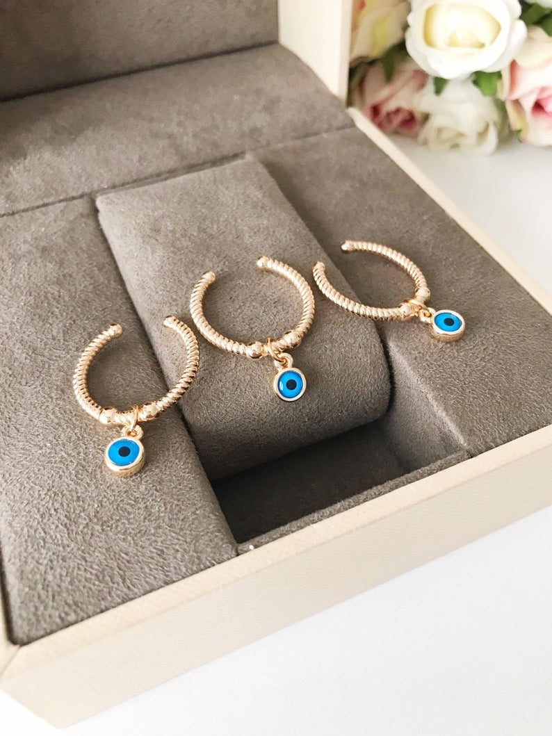 Adjustable Dangle Evil Eye Ring featuring a blue evil eye charm and cubic zirconia, elegantly designed for all finger sizes.