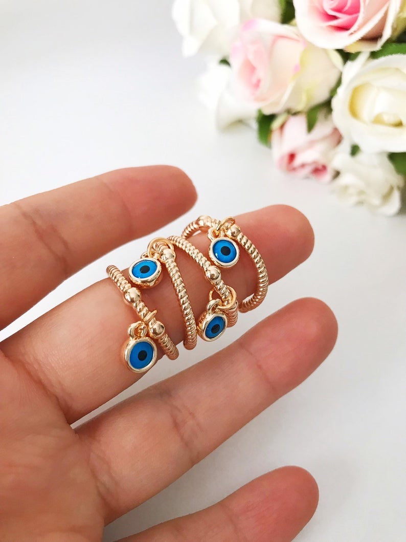 Adjustable Dangle Evil Eye Ring featuring a blue evil eye charm and cubic zirconia, elegantly designed for all finger sizes.