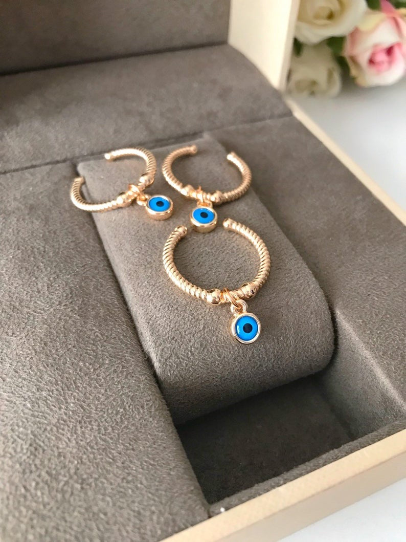 Adjustable Dangle Evil Eye Ring featuring a blue evil eye charm and cubic zirconia, elegantly designed for all finger sizes.