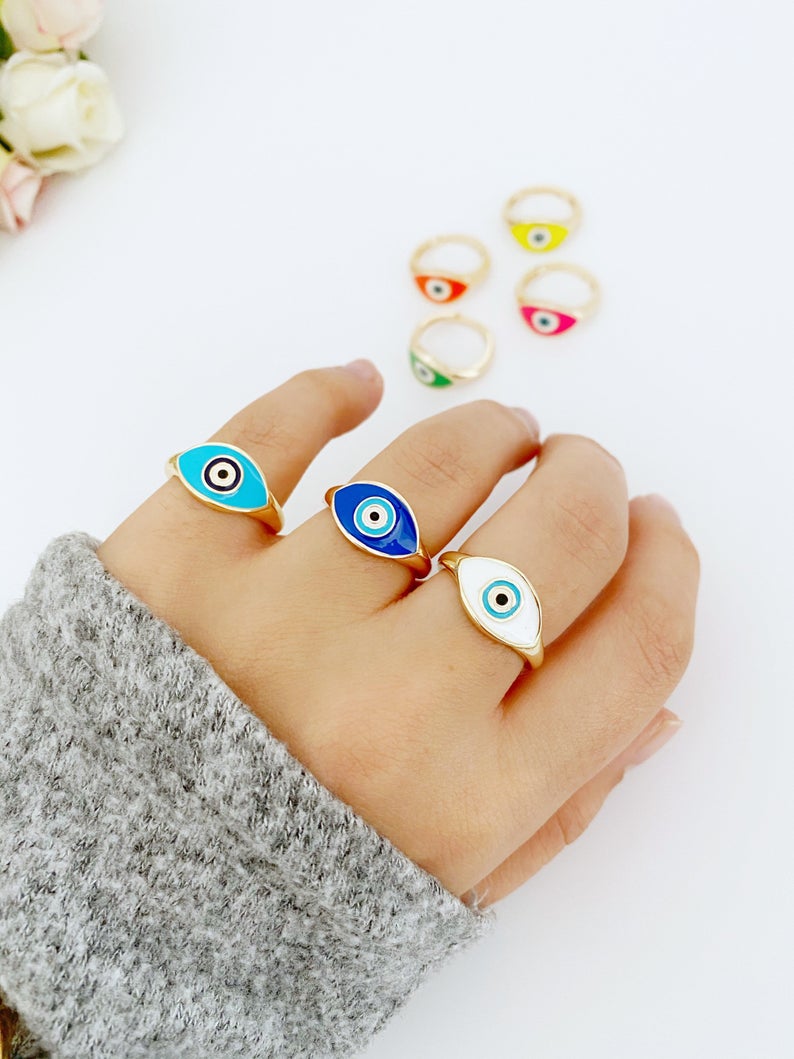 Adjustable Evil Eye Ring featuring a gold band and blue white evil eye bead, perfect for gifting and everyday wear.