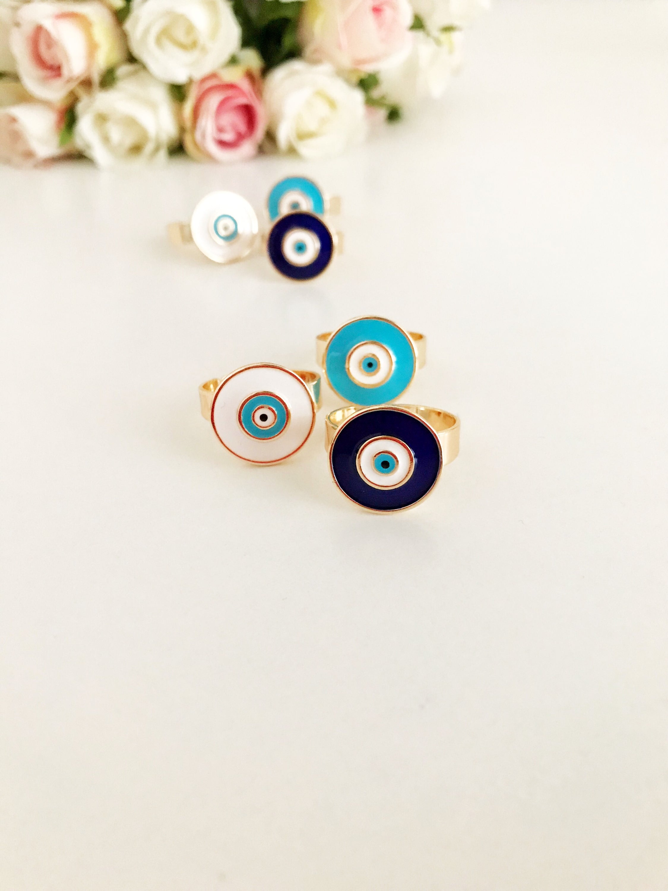 Adjustable evil eye ring featuring a blue oval bead on a rose gold band, symbolizing protection and elegance.