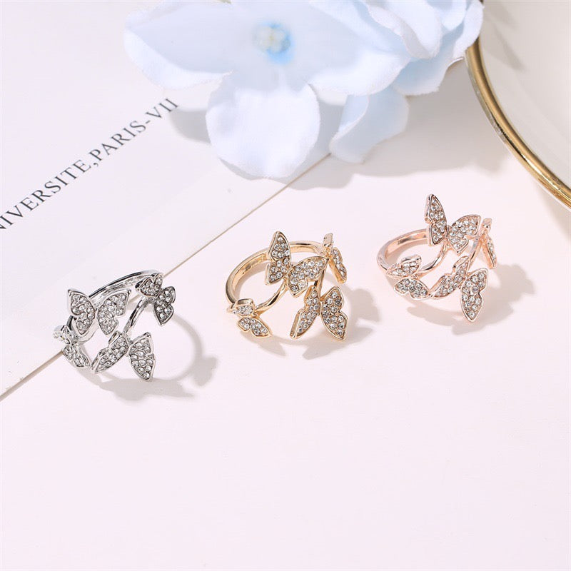 A stylish adjustable ring featuring four intricately designed butterflies made from durable alloy.