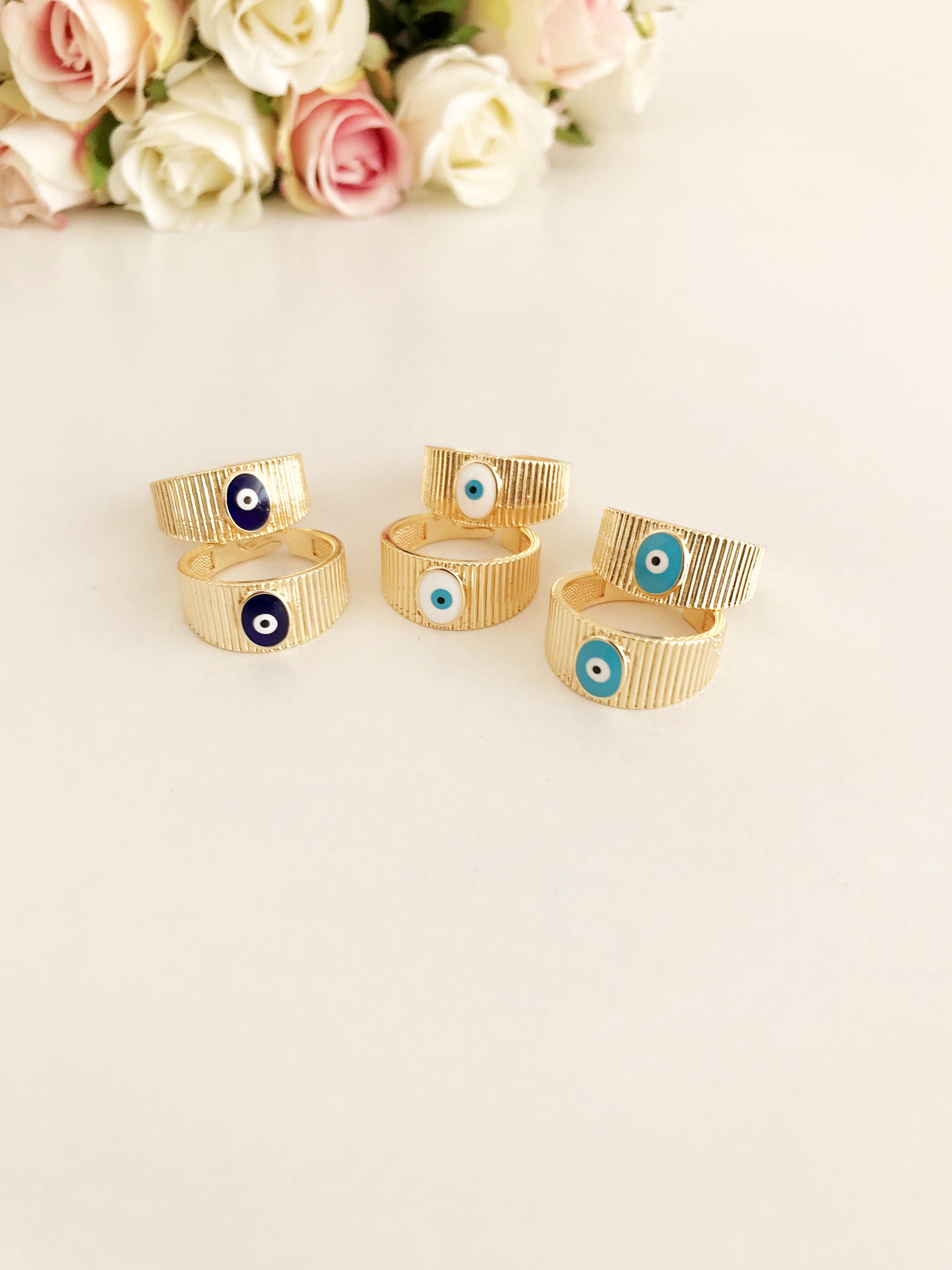 Adjustable Gold Evil Eye Ring featuring a gold band and colorful evil eye bead, symbolizing protection and style.