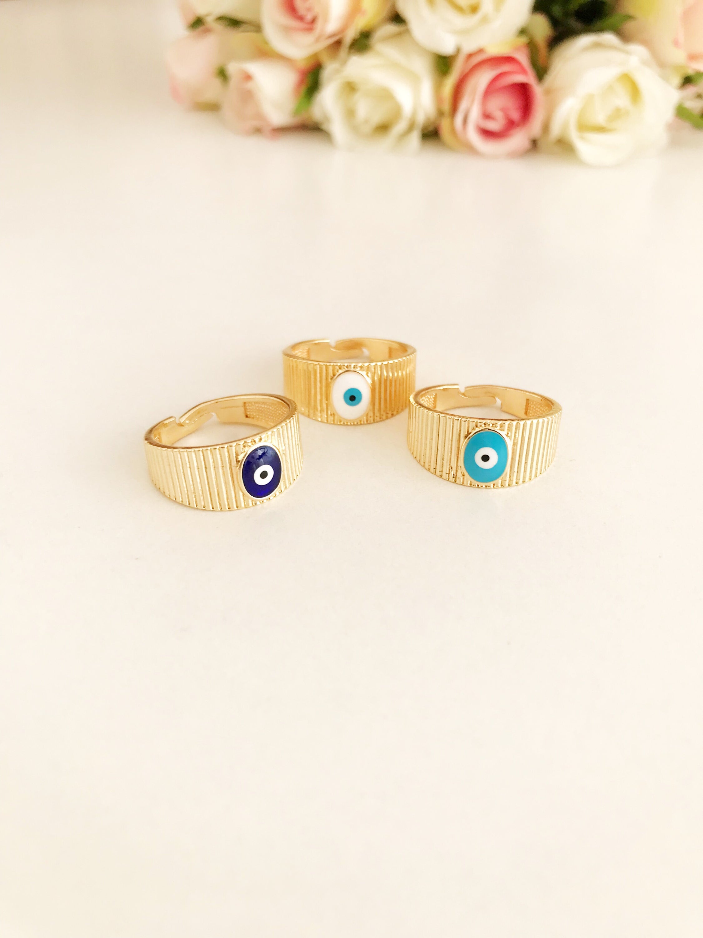 Adjustable Gold Evil Eye Ring featuring a gold band and colorful evil eye bead, symbolizing protection and style.