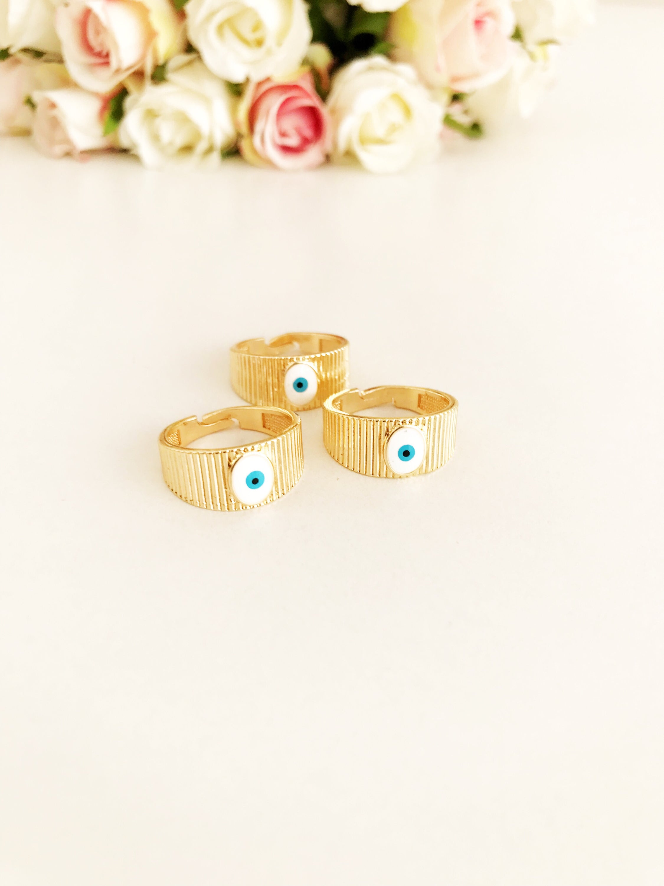 Adjustable Gold Evil Eye Ring featuring a gold band and colorful evil eye bead, symbolizing protection and style.