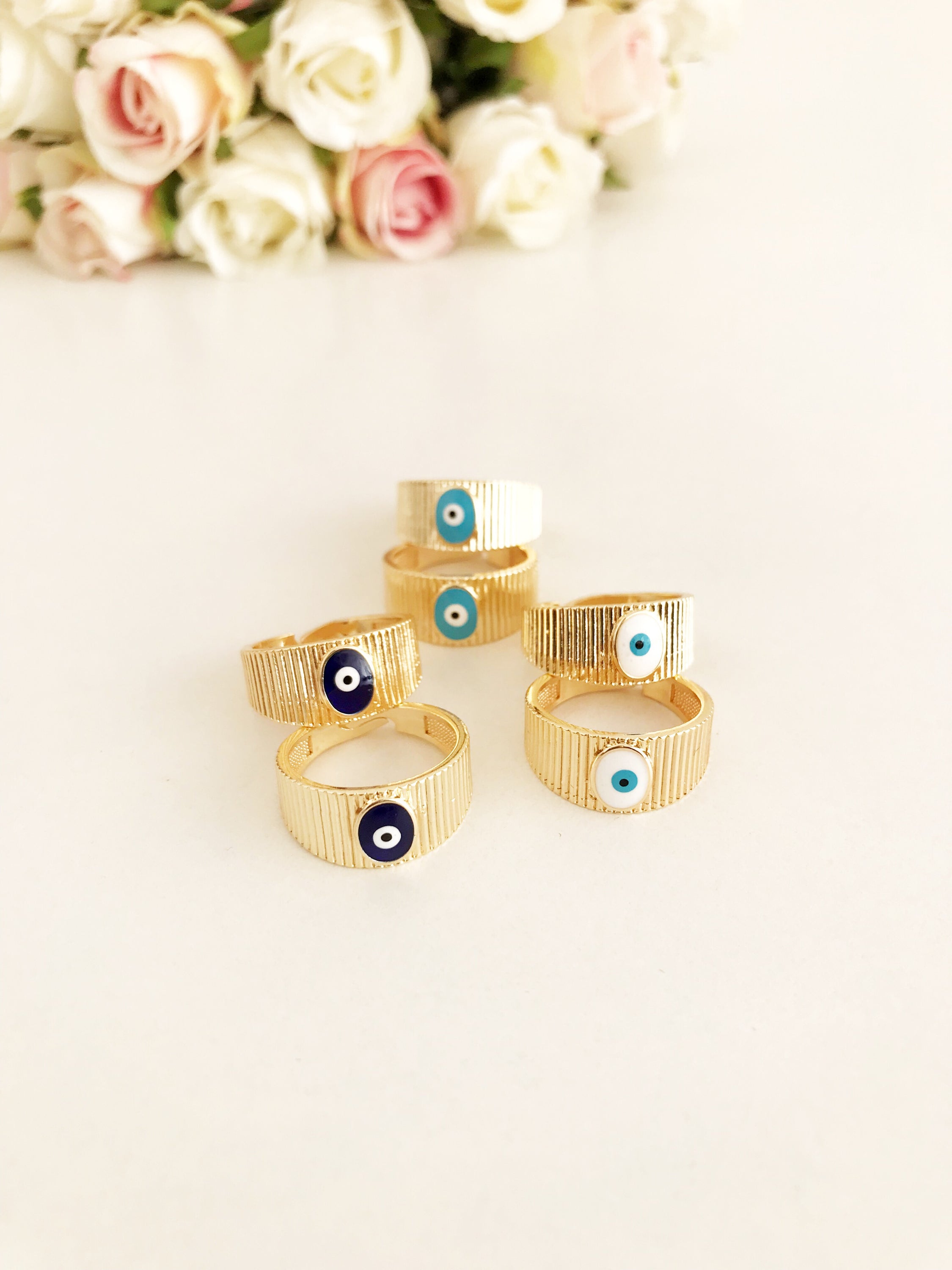 Adjustable Gold Evil Eye Ring featuring a gold band and colorful evil eye bead, symbolizing protection and style.