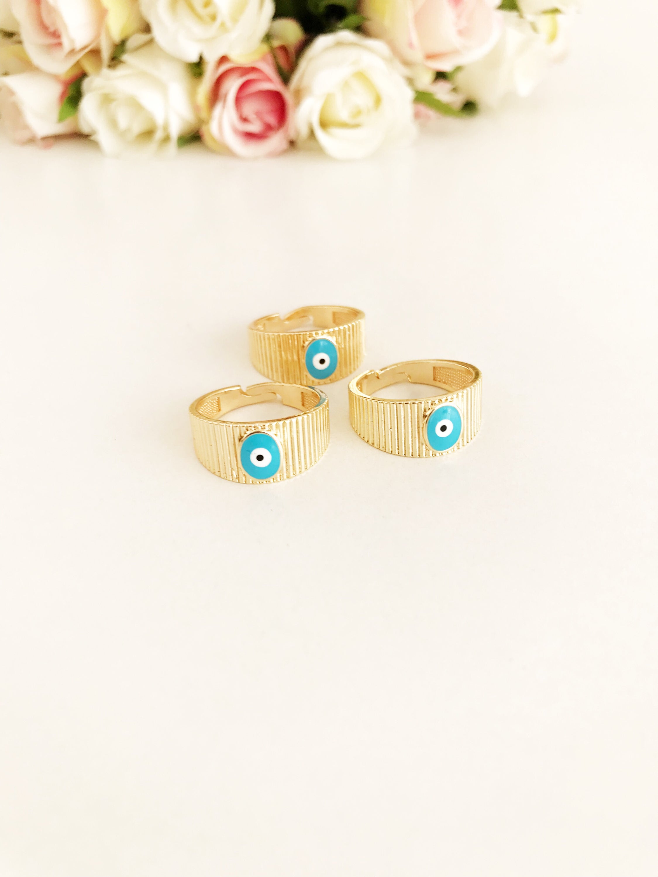 Adjustable Gold Evil Eye Ring featuring a gold band and colorful evil eye bead, symbolizing protection and style.