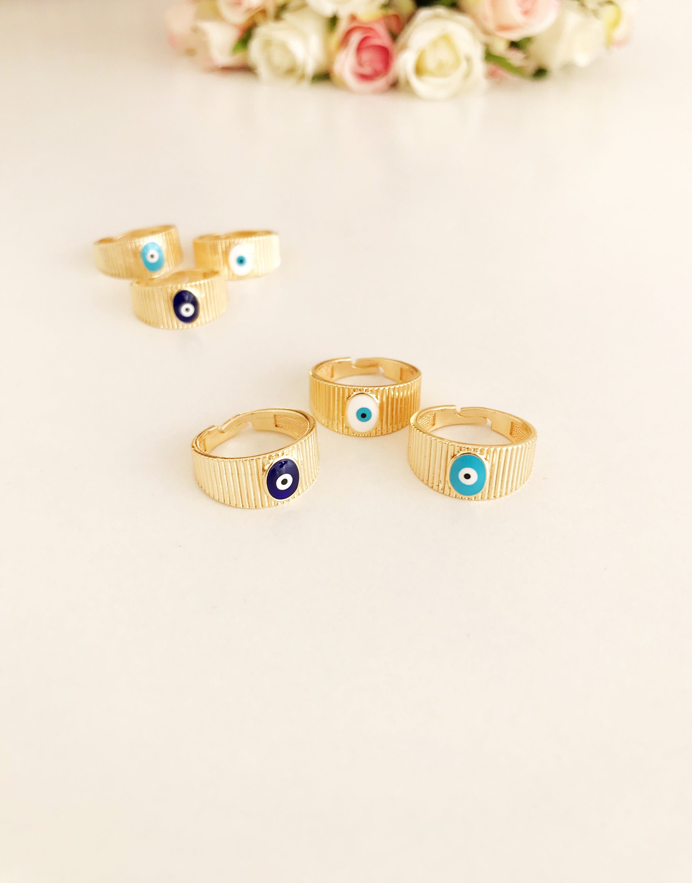 Adjustable Gold Evil Eye Ring featuring a gold band and colorful evil eye bead, symbolizing protection and style.