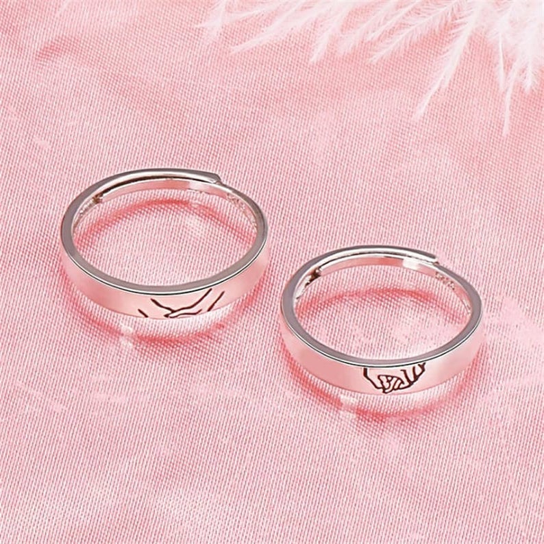 Adjustable Hand Holding Matching Couple Band Promise Ring Set in elegant silver, symbolizing love and unity for couples.