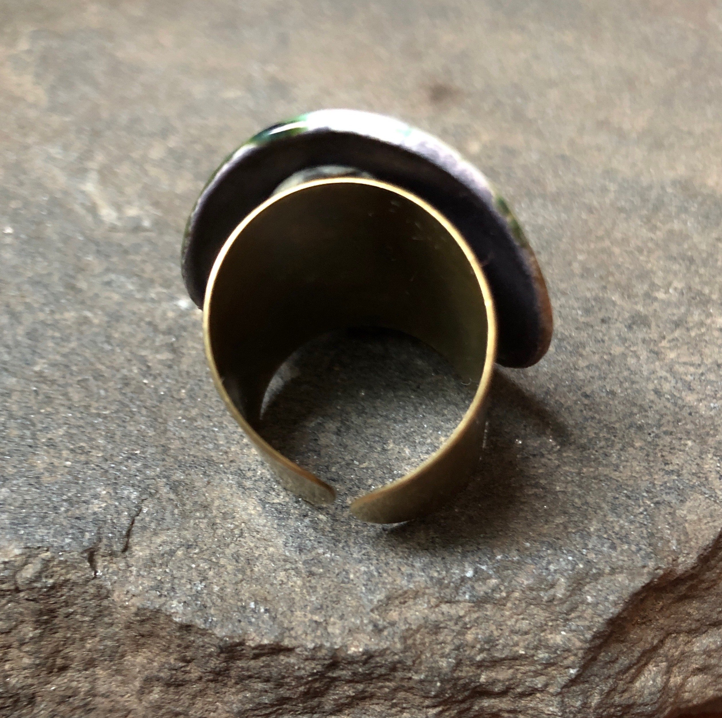 Adjustable handmade teal ceramic band statement cocktail ring with a bronze base, showcasing a unique design and vibrant color.