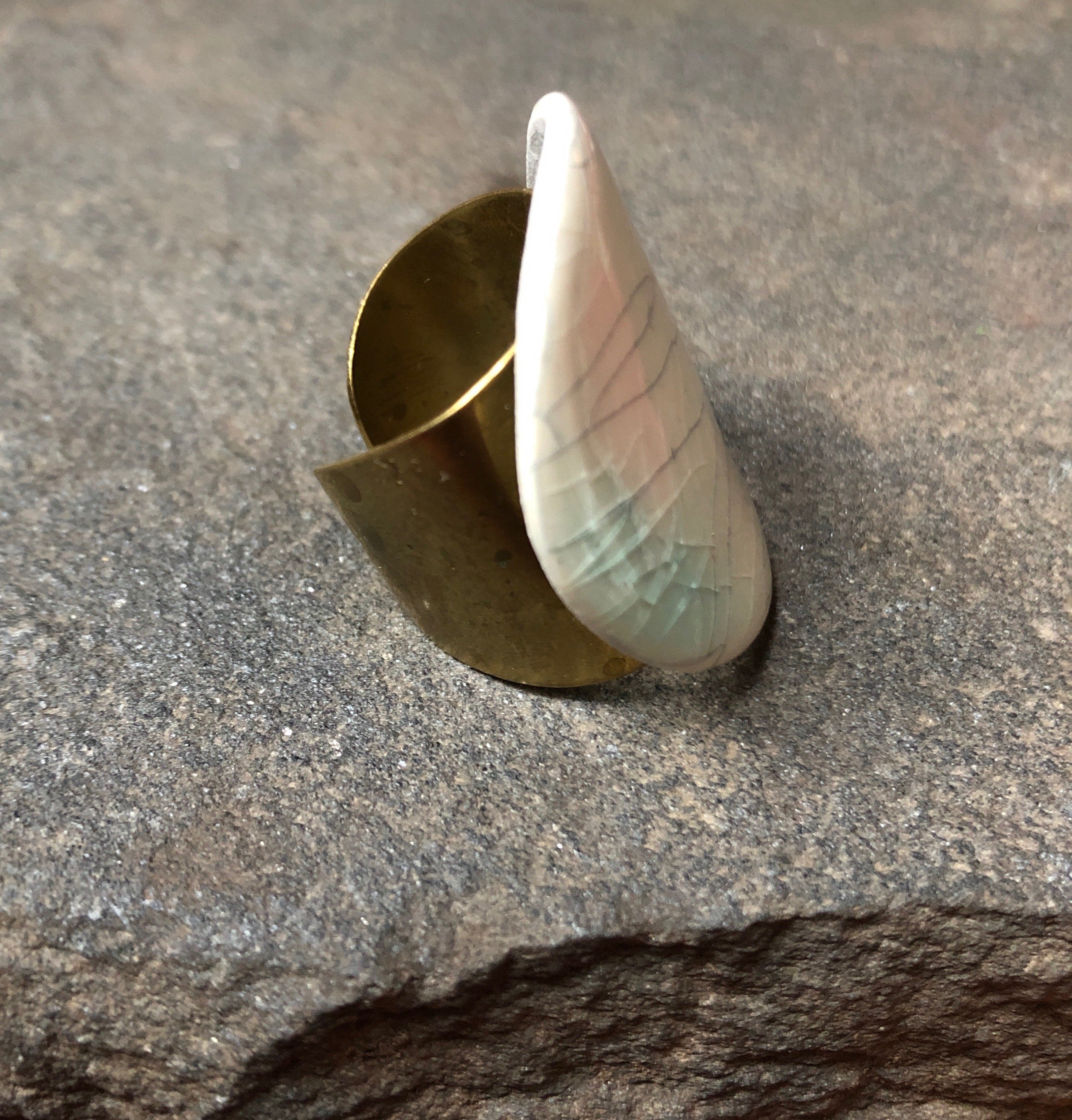 Adjustable handmade teal ceramic band statement cocktail ring with a bronze base, showcasing a unique design and vibrant color.