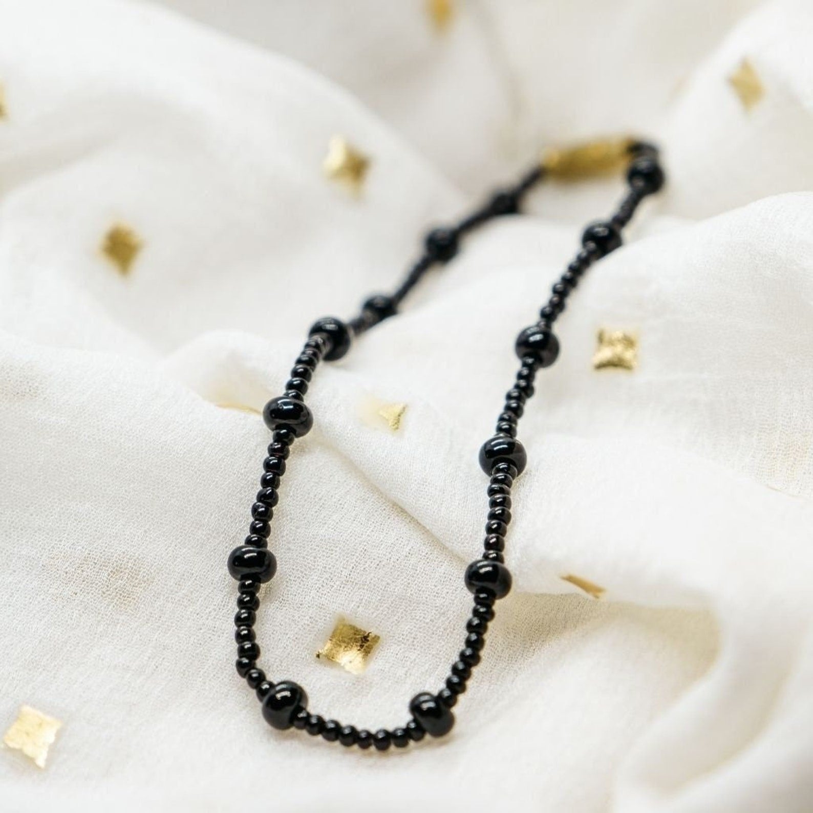 Adjustable Nazaria Black Beaded Bracelet for newborns, featuring high-quality black beads in a minimalist design.