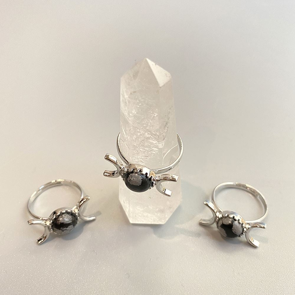 Adjustable ring featuring a 0.5cm gemstone, showcasing its unique design and craftsmanship.