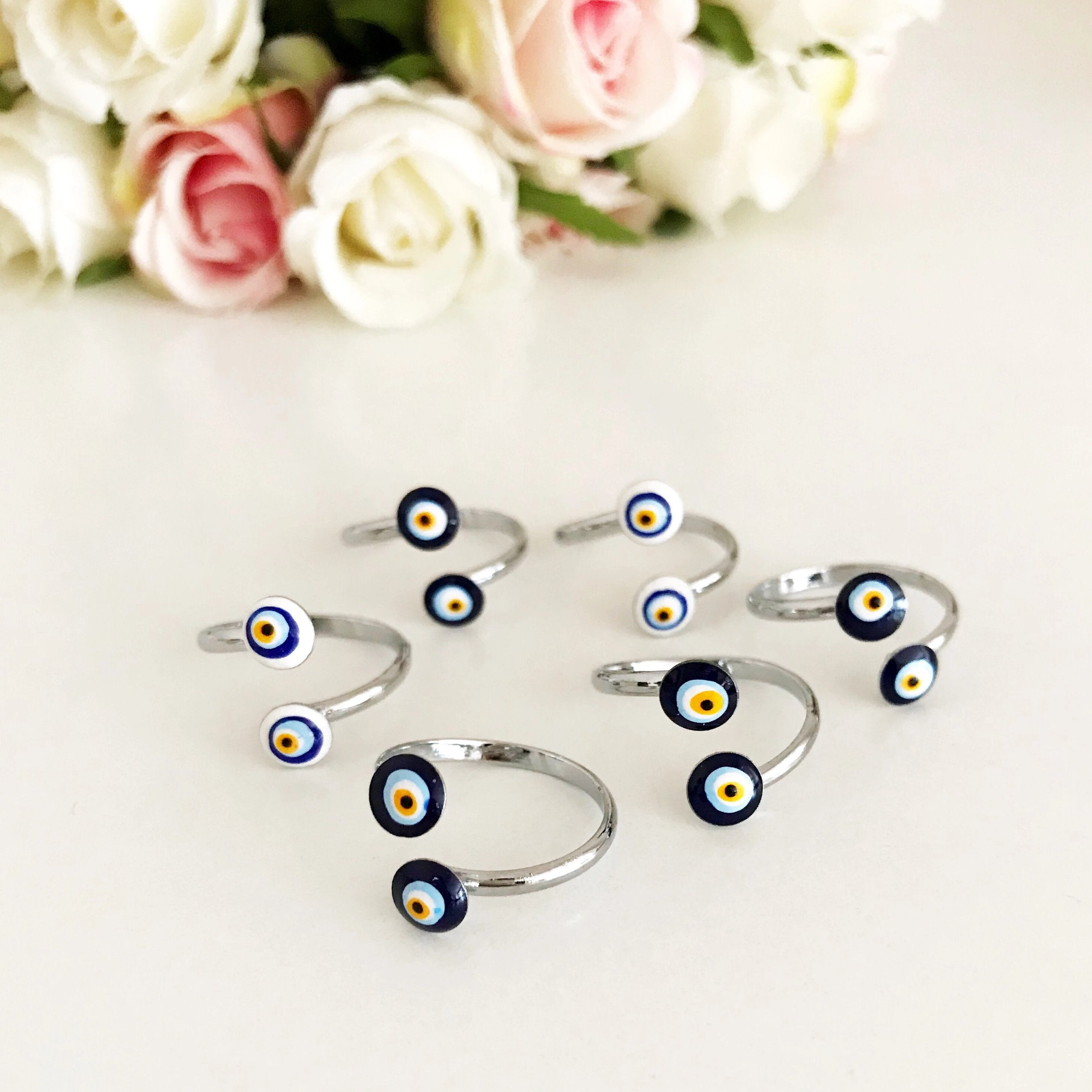 Adjustable silver ring featuring a blue and white evil eye bead, symbolizing protection and good luck.