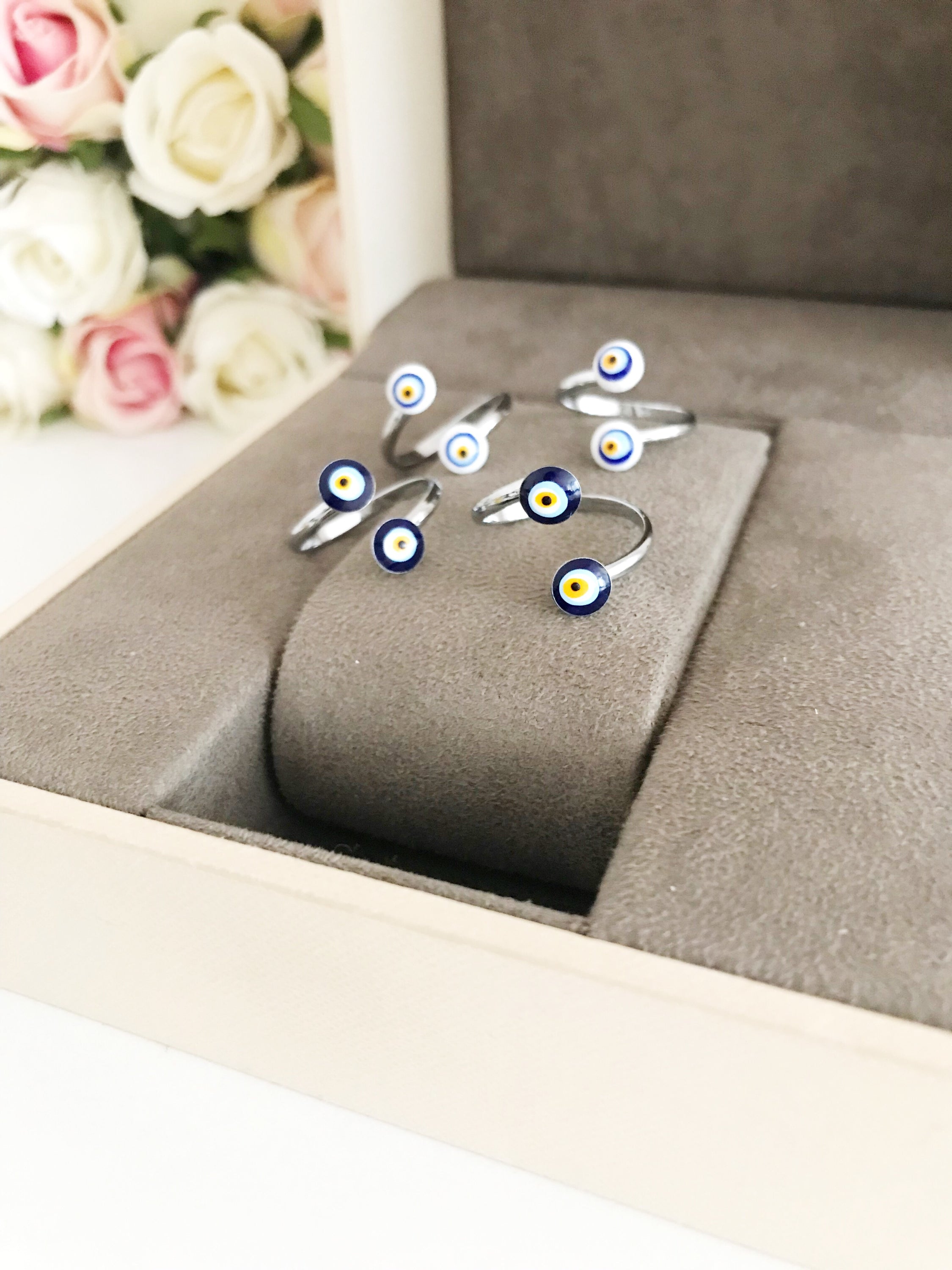 Adjustable silver ring featuring a blue and white evil eye bead, symbolizing protection and good luck.