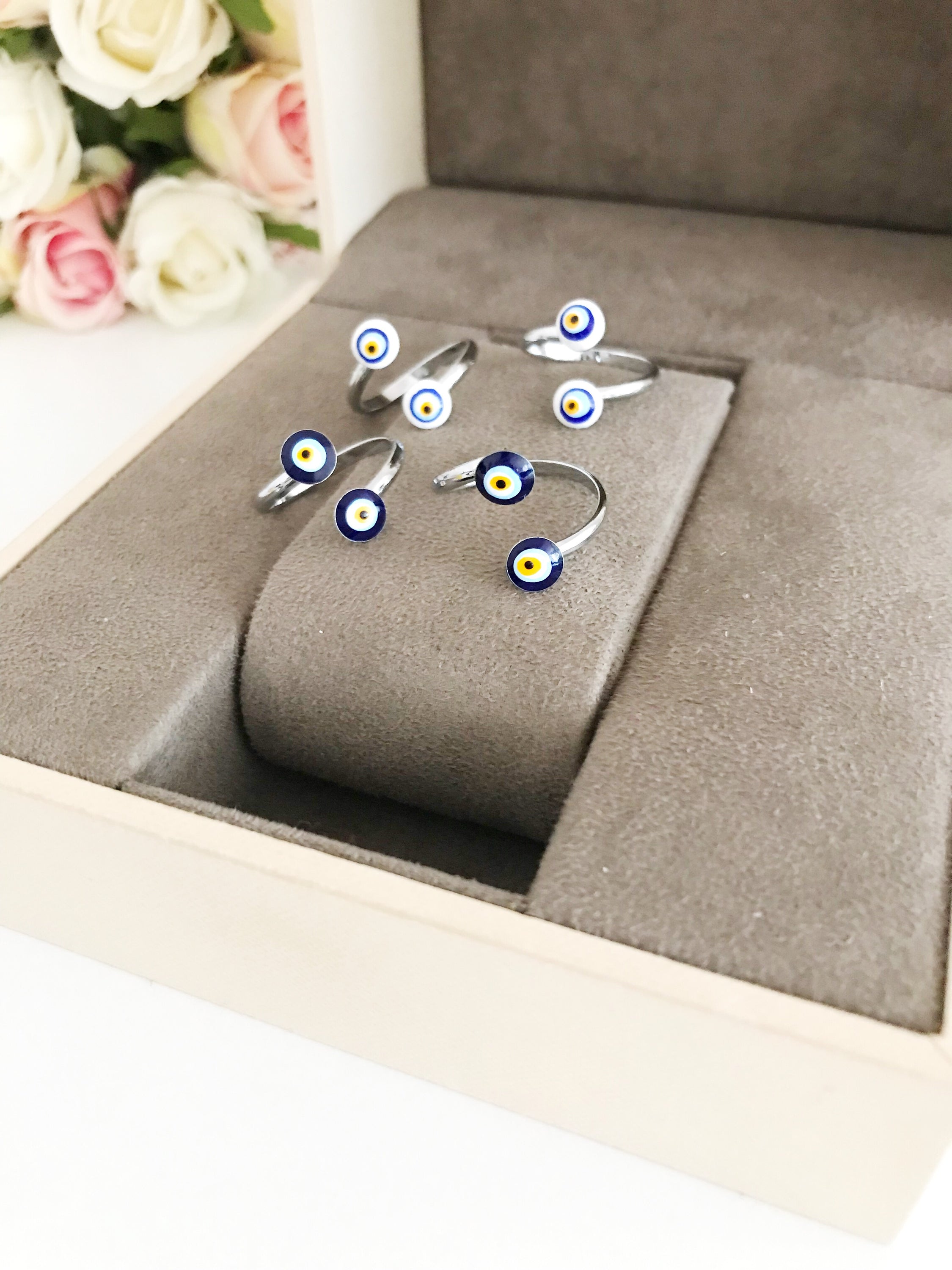 Adjustable silver ring featuring a blue and white evil eye bead, symbolizing protection and good luck.