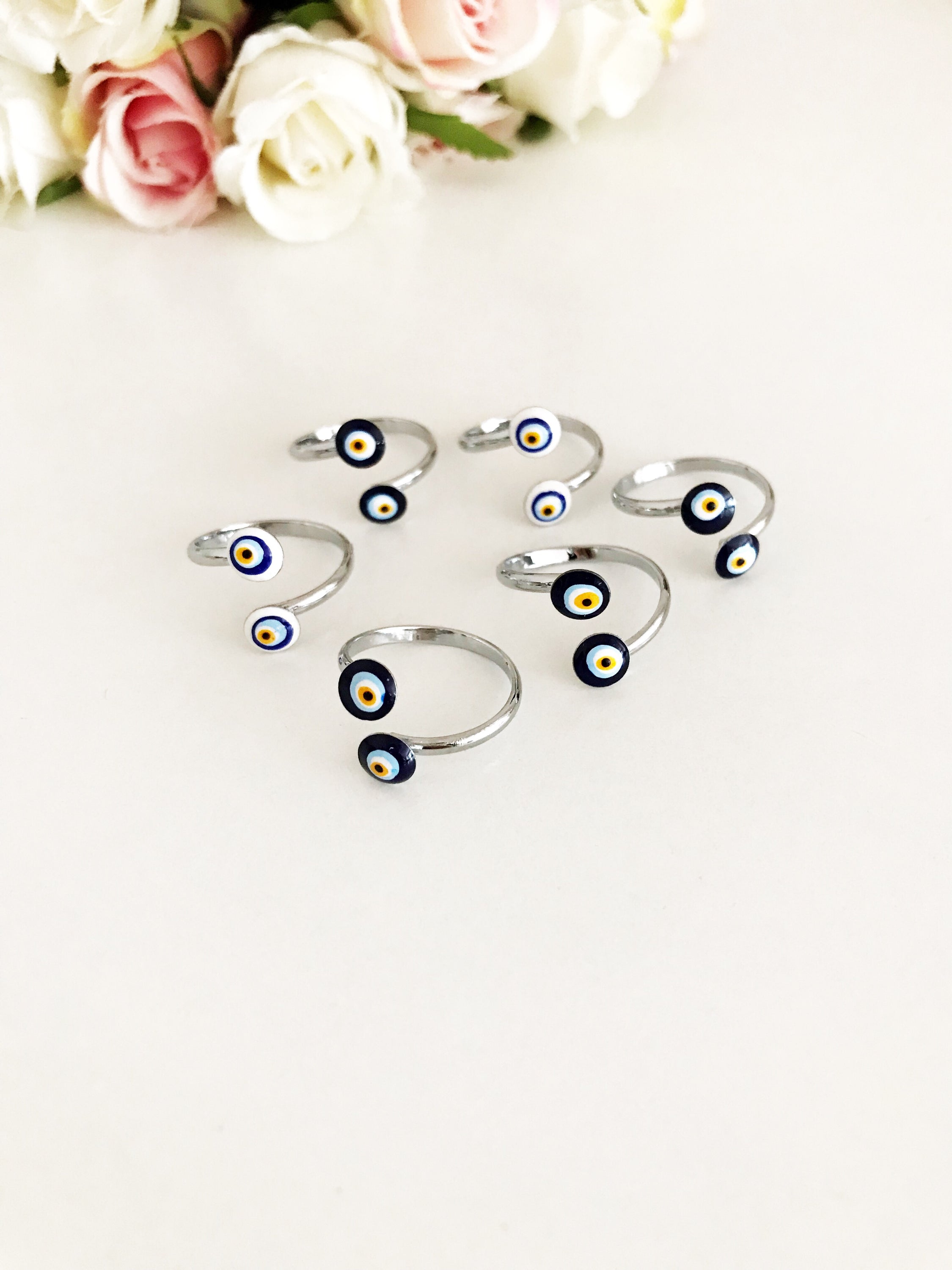 Adjustable silver ring featuring a blue and white evil eye bead, symbolizing protection and good luck.