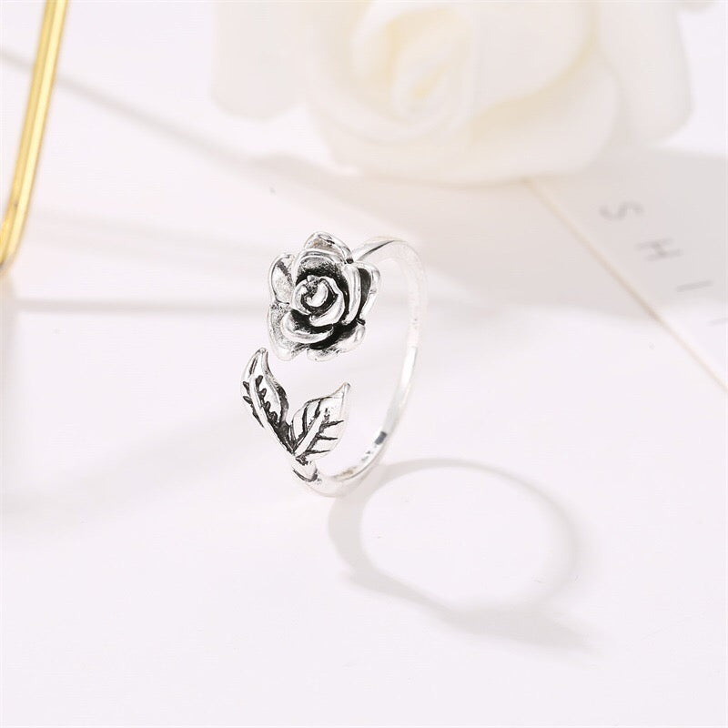 Adjustable vintage rose open ring made of copper with rhinestone embellishments, showcasing a delicate rose design.