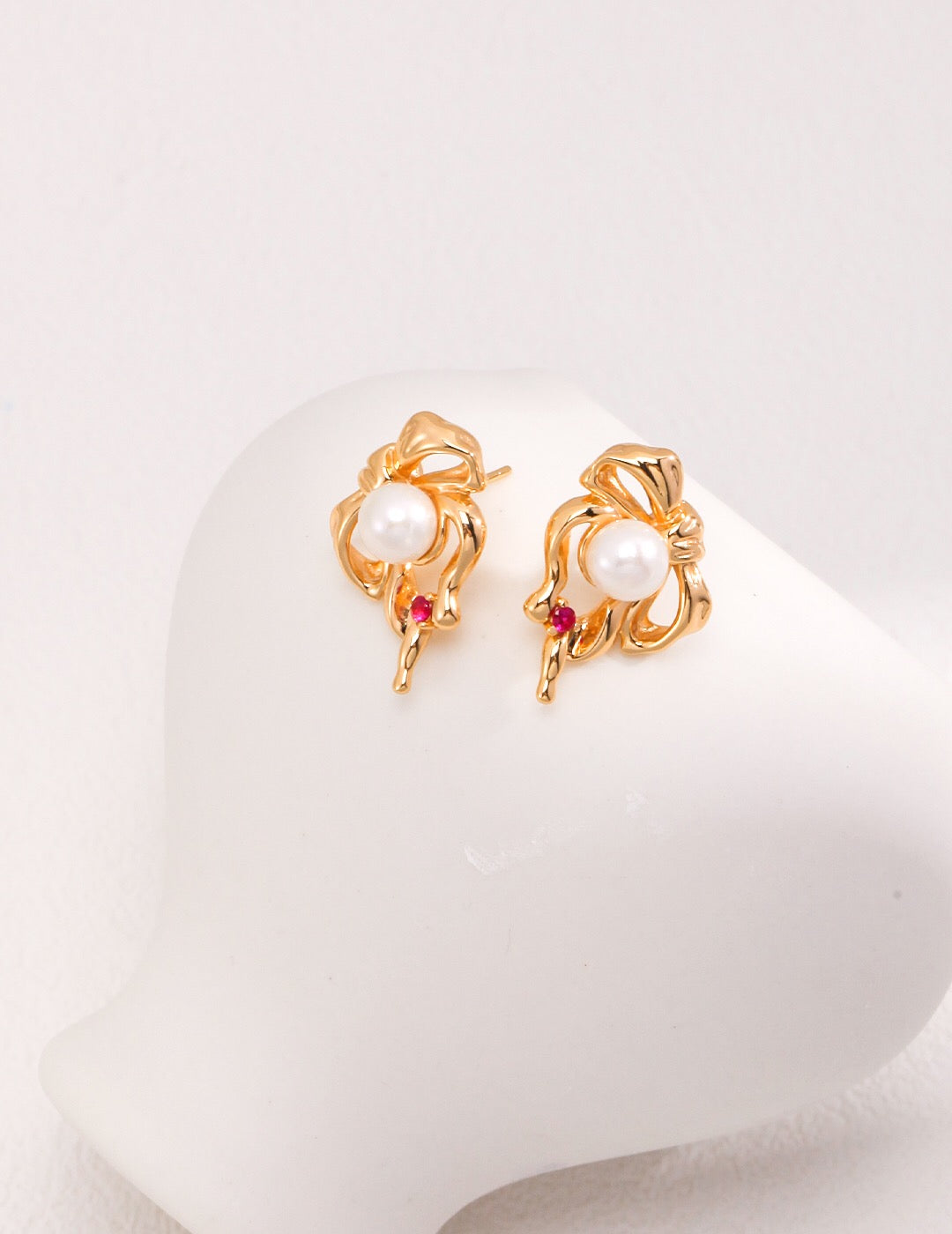 Adorable Bow And Pearl Stud earrings featuring a delicate bow design with a lustrous baroque pearl, crafted from sterling silver and gold vermeil.