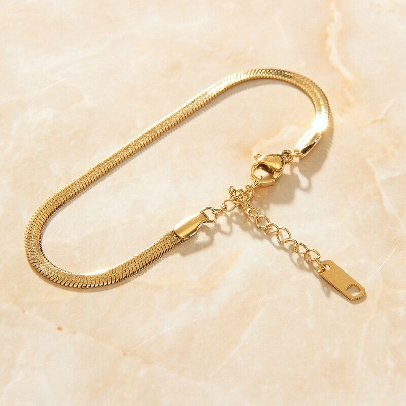 Agapi 4mm Snake Chain Bracelet in rich gold, showcasing its dainty design and adjustable length.