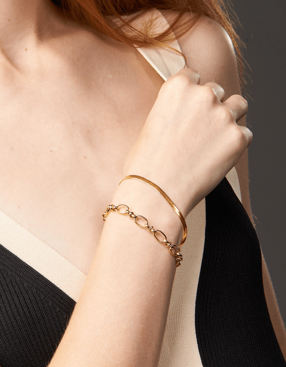 Agapi 4mm Snake Chain Bracelet in rich gold, showcasing its dainty design and adjustable length.