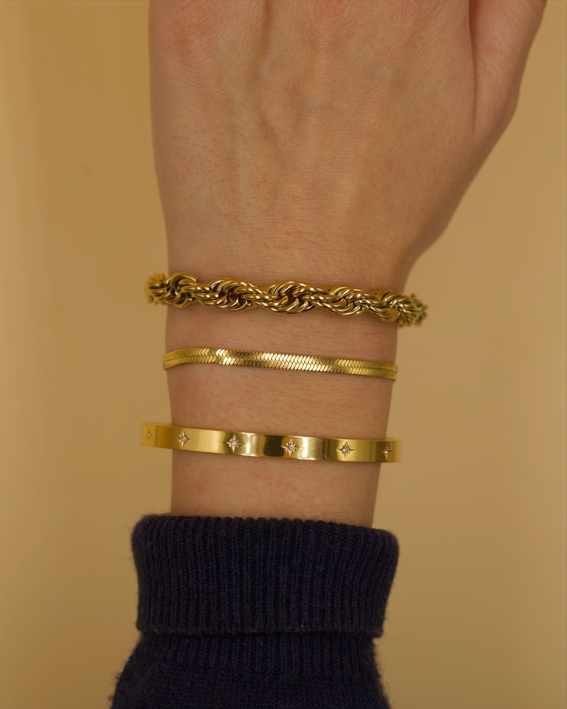 Agapi 4mm Snake Chain Bracelet in rich gold, showcasing its dainty design and adjustable length.