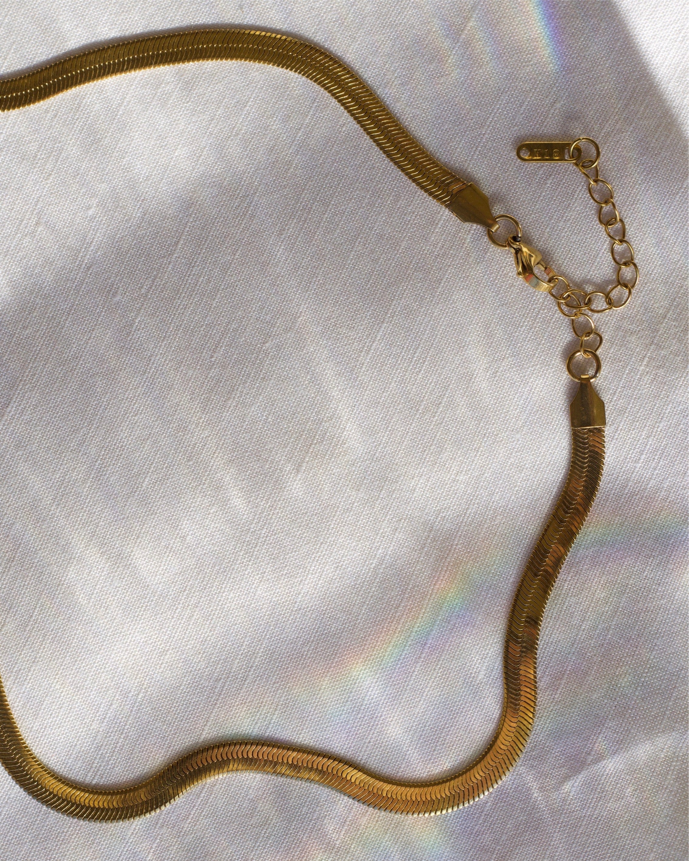 Agapi 5mm Snake Necklace Choker in rich gold, showcasing its elegant design and adjustable length.