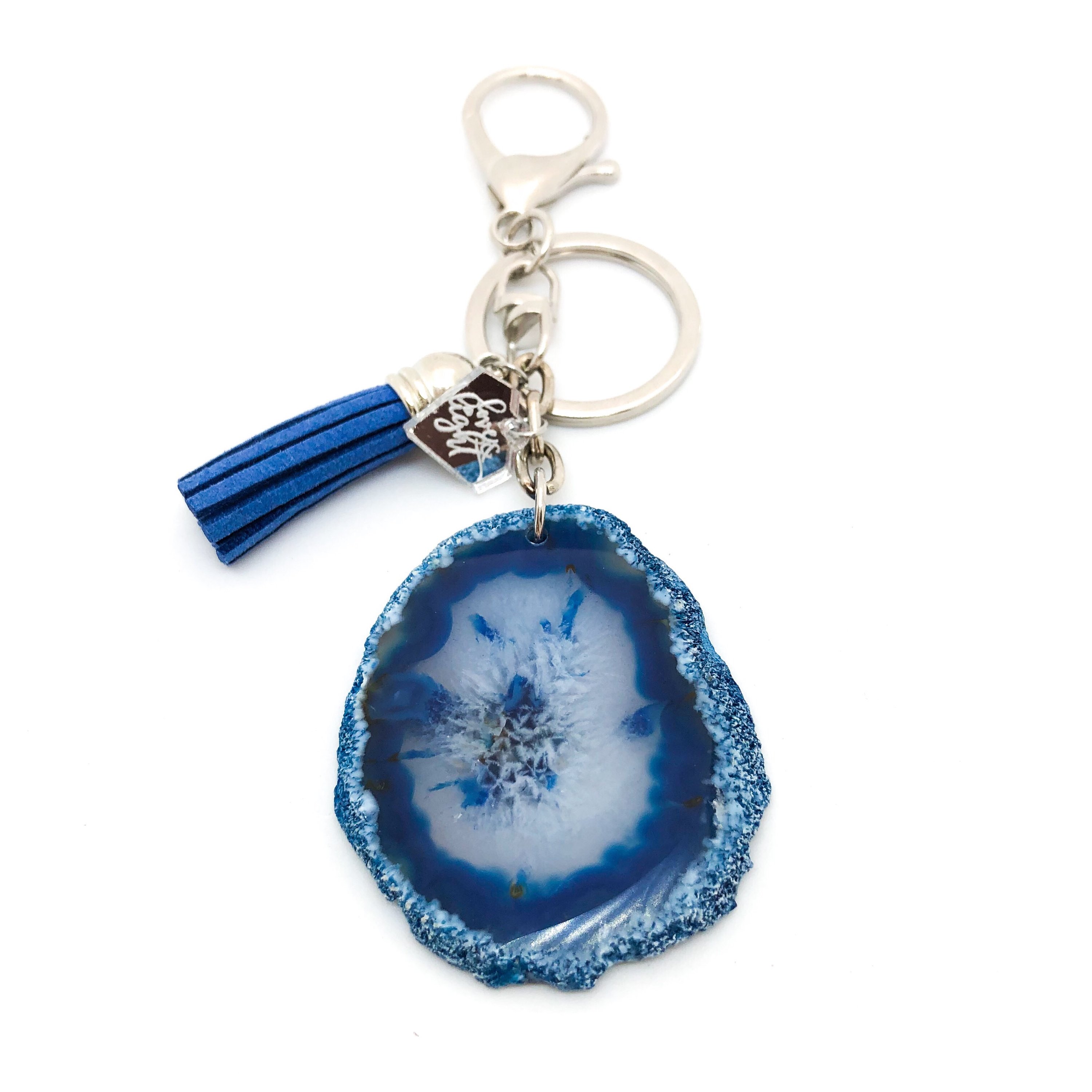 Colorful Agate Slice Keychain with suede tassel and LLJ charm, showcasing unique shapes and vibrant colors.