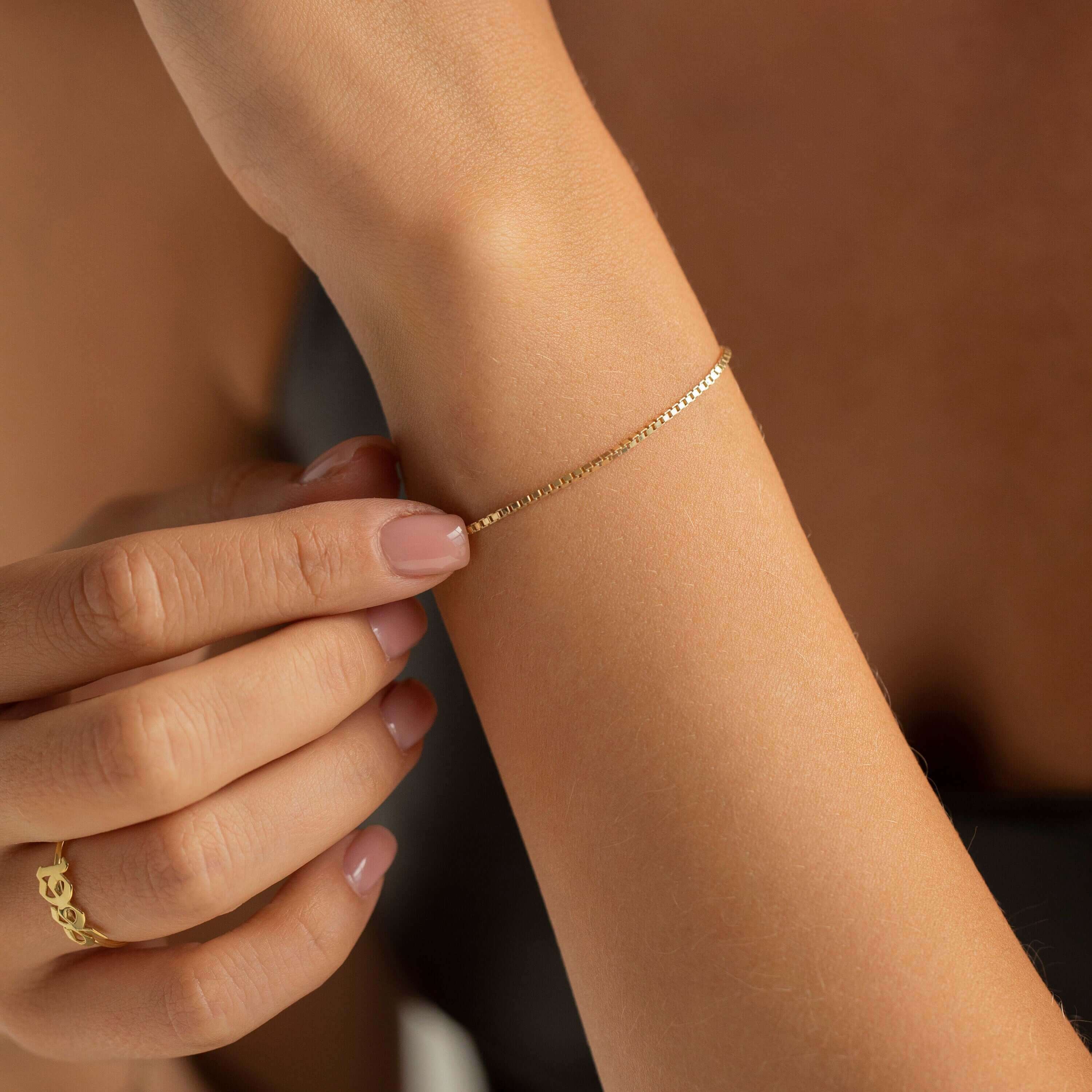 A collection of FARAA's minimalist Arabic bracelets showcasing sleek lines and elegant designs, crafted in Qatar.