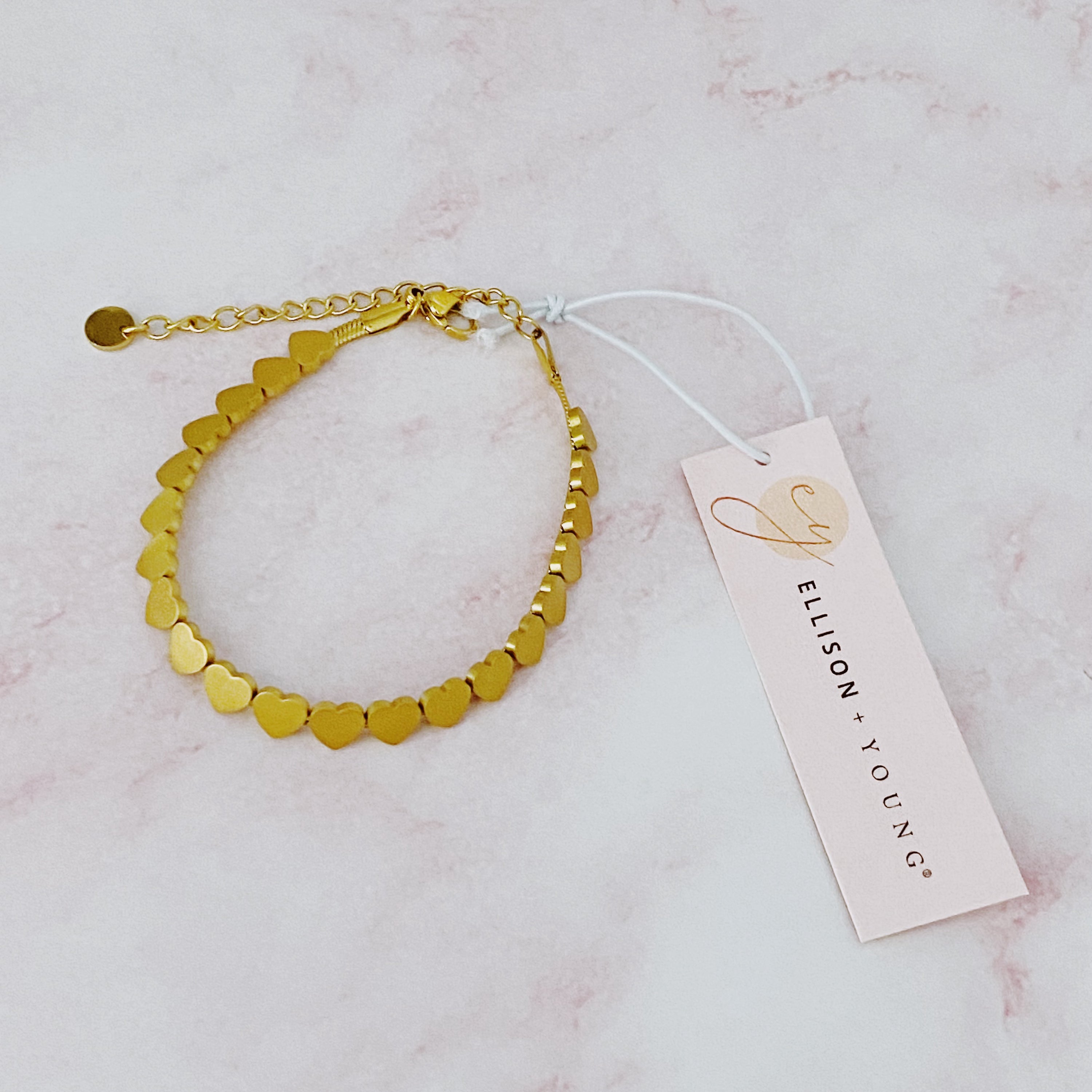 All Around Mini Hearts Bracelet featuring small gold-plated hearts on a delicate chain, showcasing elegance and craftsmanship.