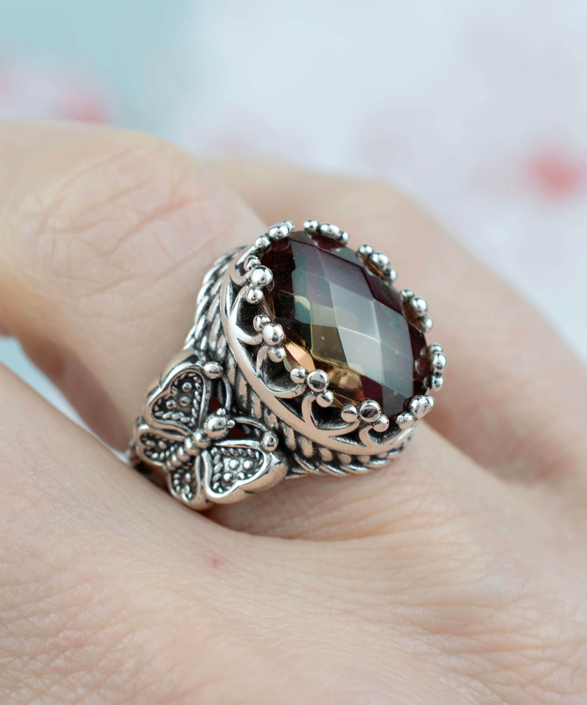 Alexandrite gemstone filigree art double butterfly ring crafted from 925 sterling silver, showcasing intricate detailing and a stunning color-changing gemstone.