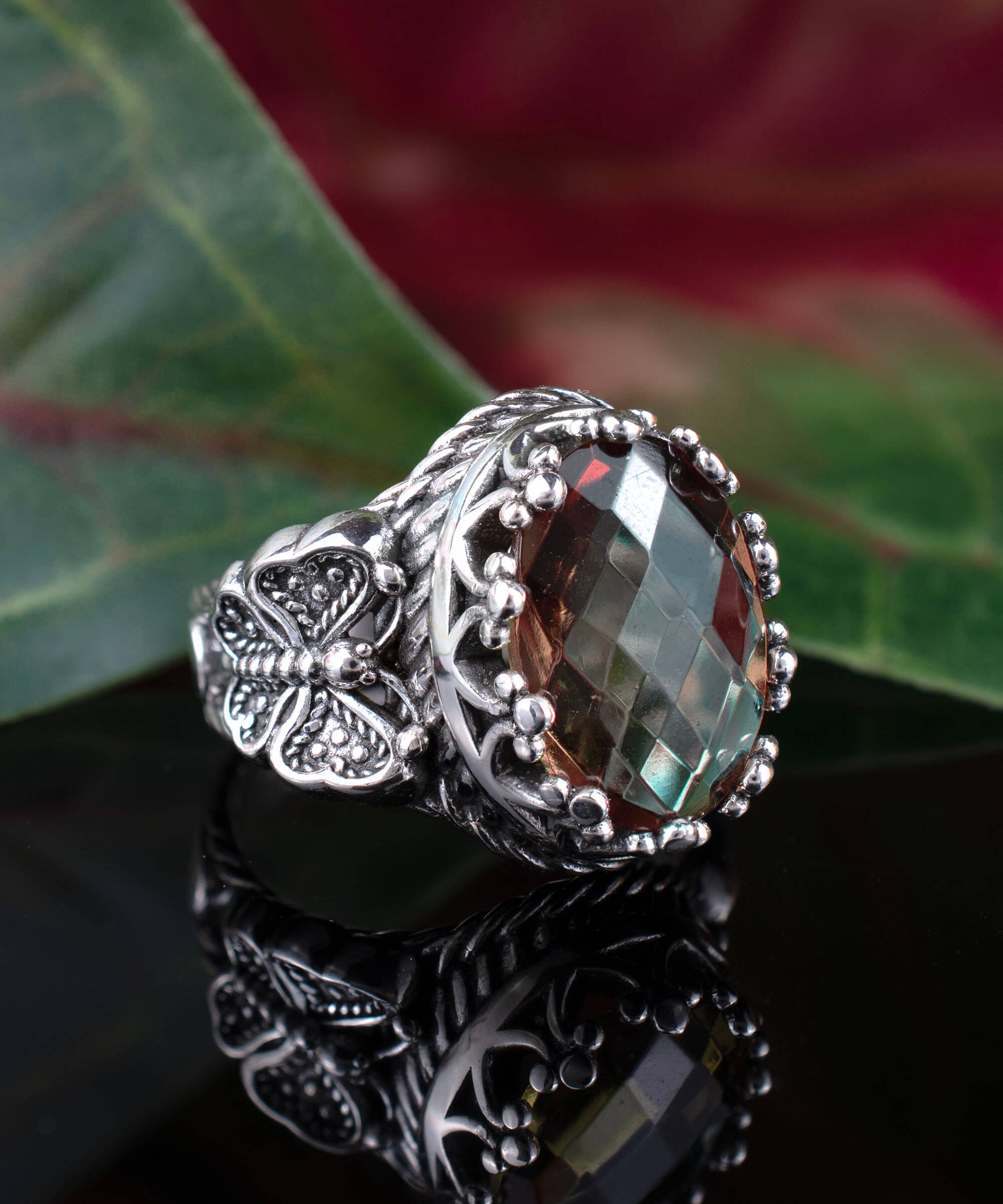 Alexandrite gemstone filigree art double butterfly ring crafted from 925 sterling silver, showcasing intricate detailing and a stunning color-changing gemstone.