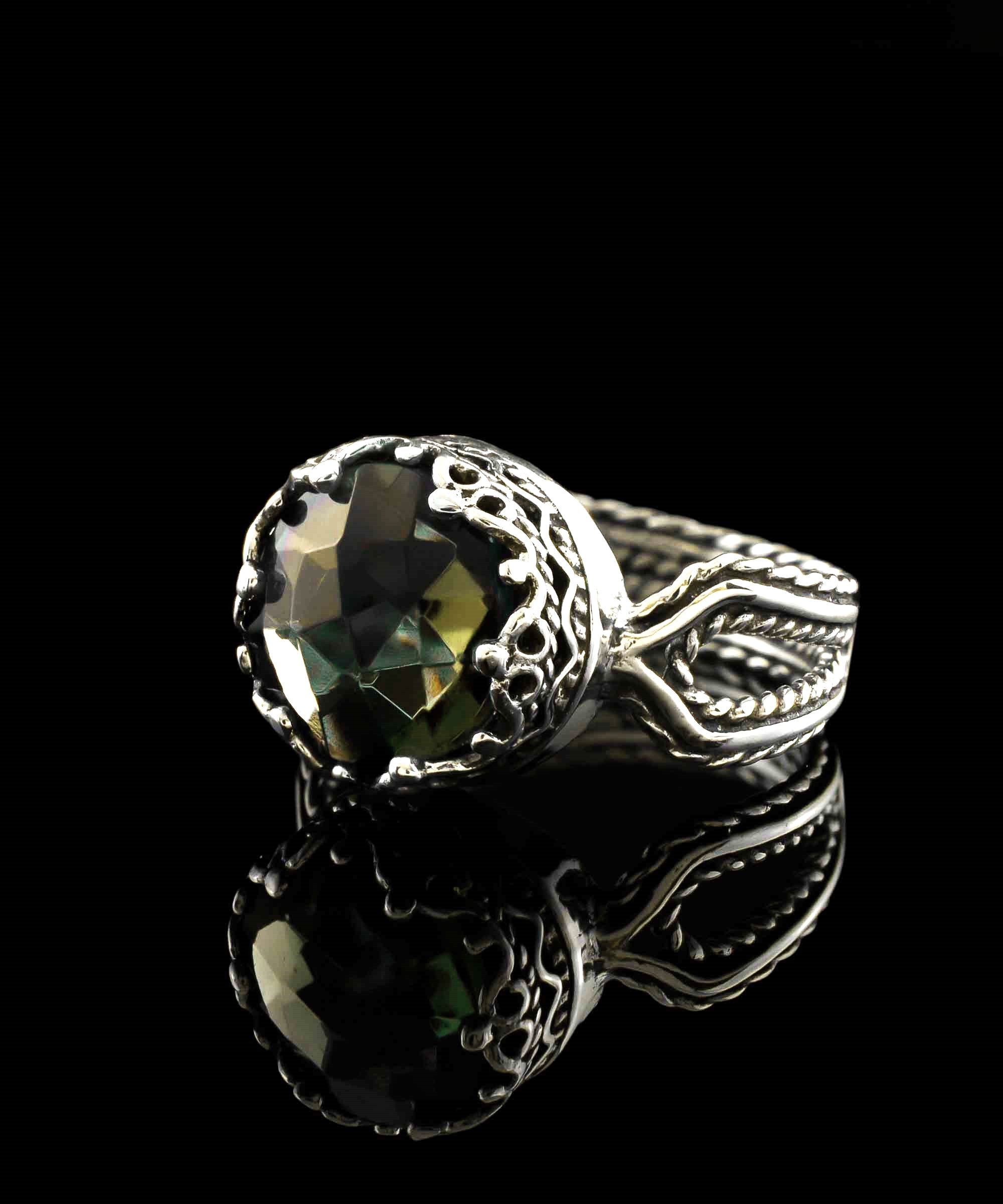 Elegant Alexandrite gemstone cocktail ring in sterling silver with intricate filigree design, showcasing a round-cut purple stone.