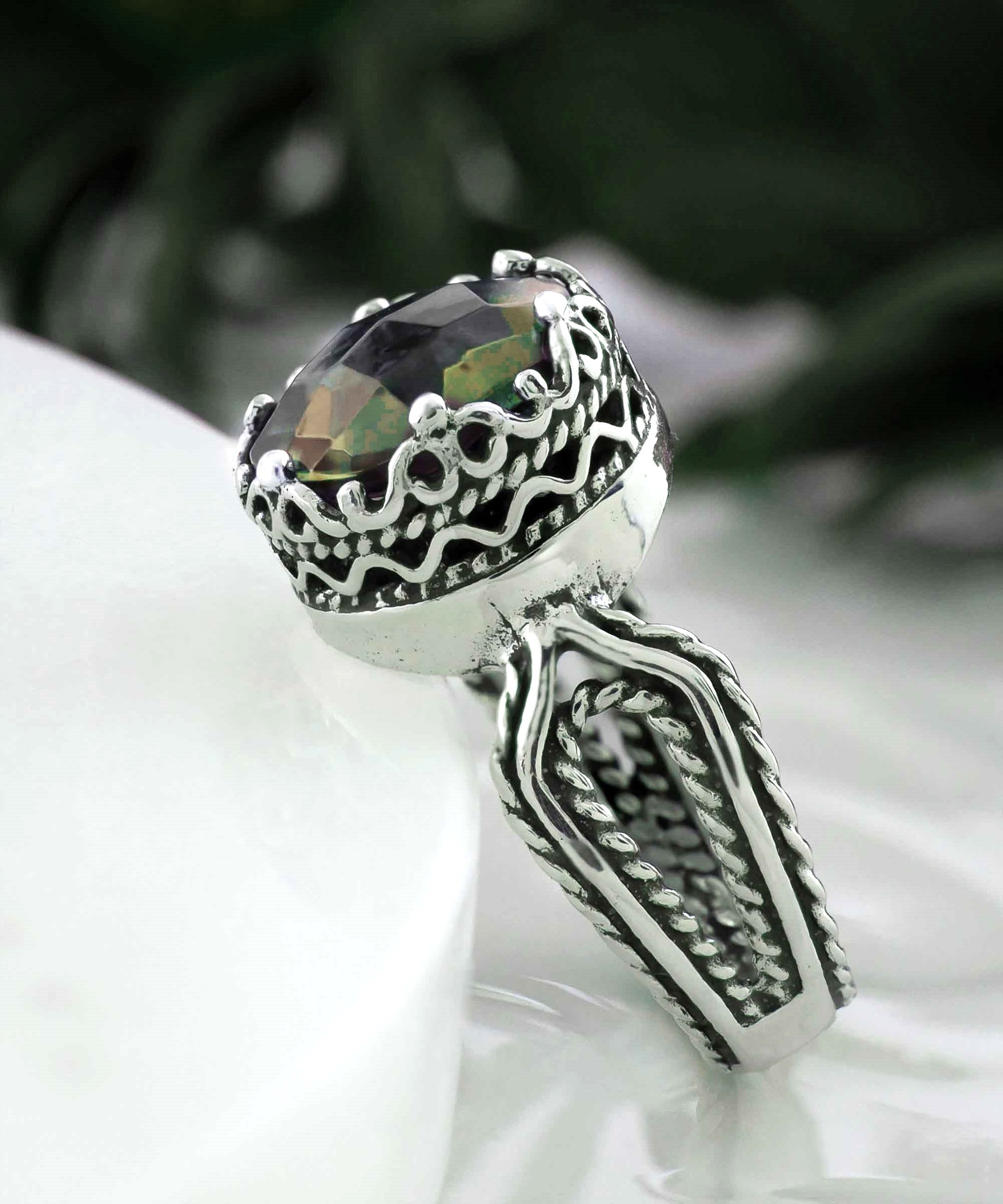 Elegant Alexandrite gemstone cocktail ring in sterling silver with intricate filigree design, showcasing a round-cut purple stone.