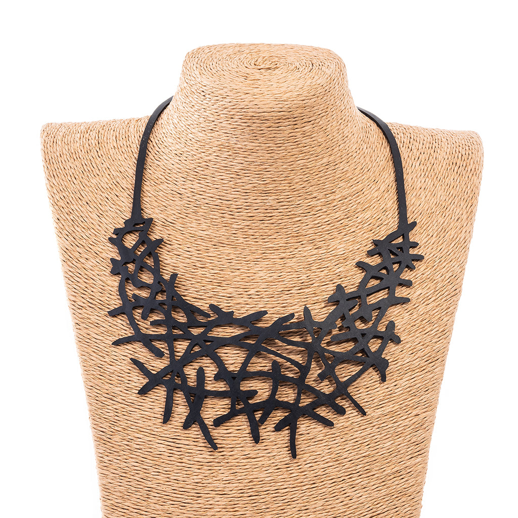 Alga Eco-Friendly Rubber Necklace made from recycled materials, showcasing its unique design and craftsmanship.