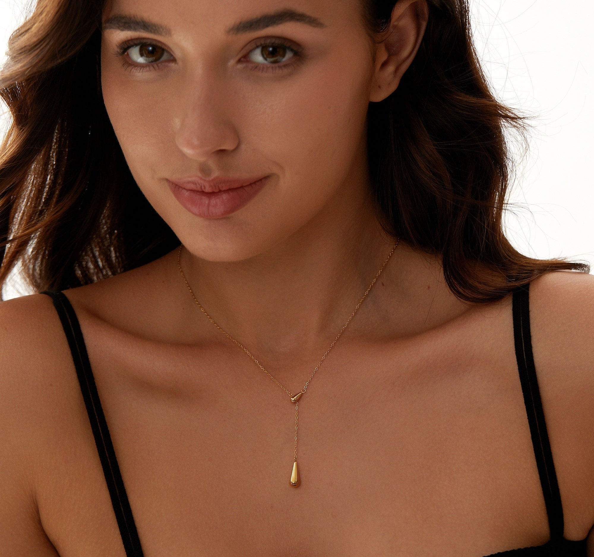 Aaliyah 18K Gold Teardrop Necklace featuring a glossy gold finish and adjustable length, elegantly displayed on a soft background.