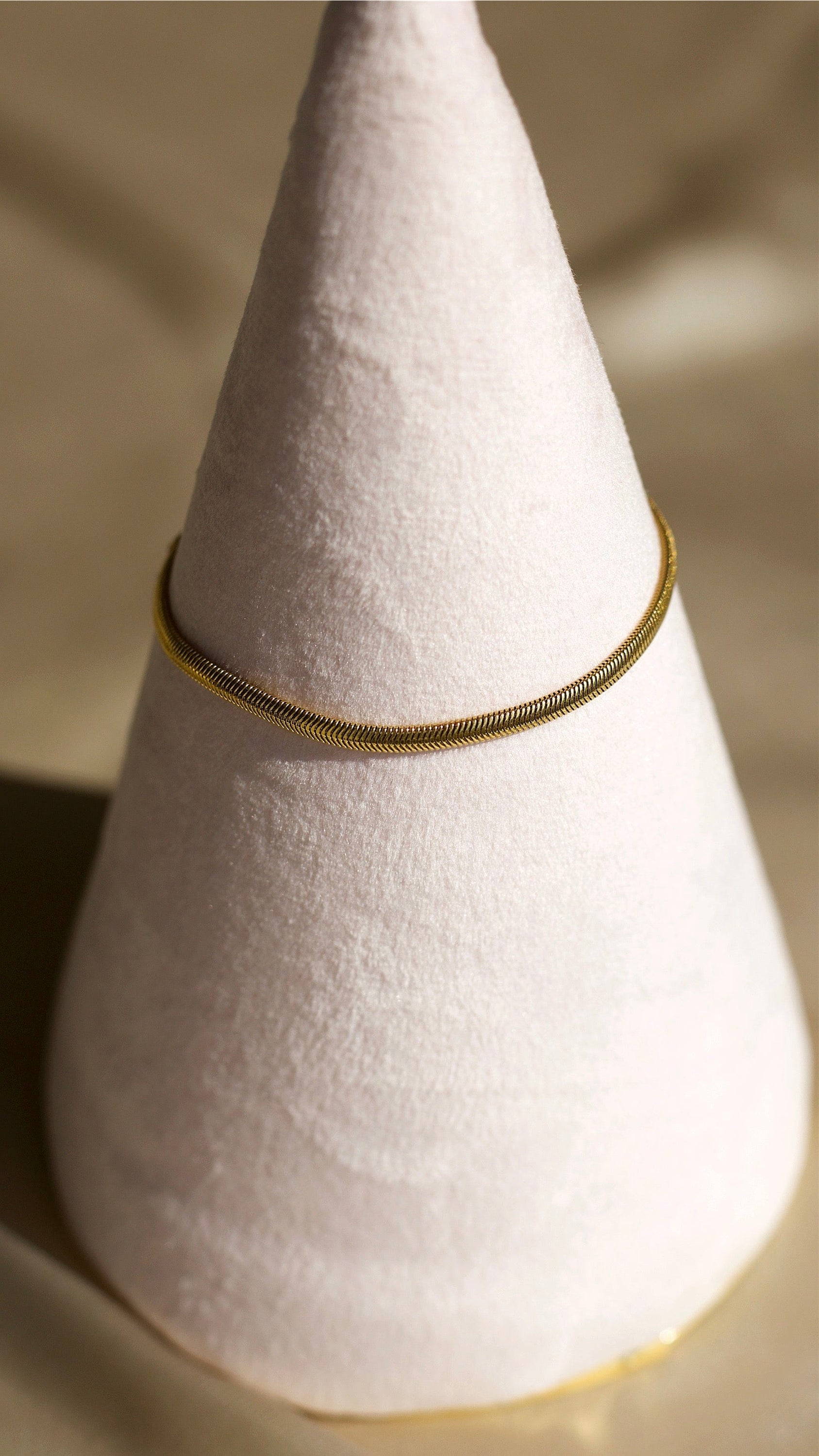 Alonna 3mm Women's Herringbone Bracelet in rich gold, showcasing its delicate design and adjustable clasp.