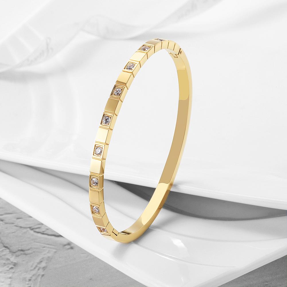 Alternate Pavé Stone Hinged Bangle made of surgical stainless steel with gold plating and sparkling stones.