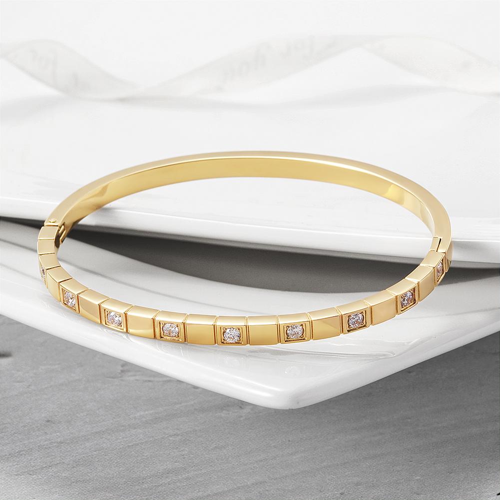 Alternate Pavé Stone Hinged Bangle made of surgical stainless steel with gold plating and sparkling stones.