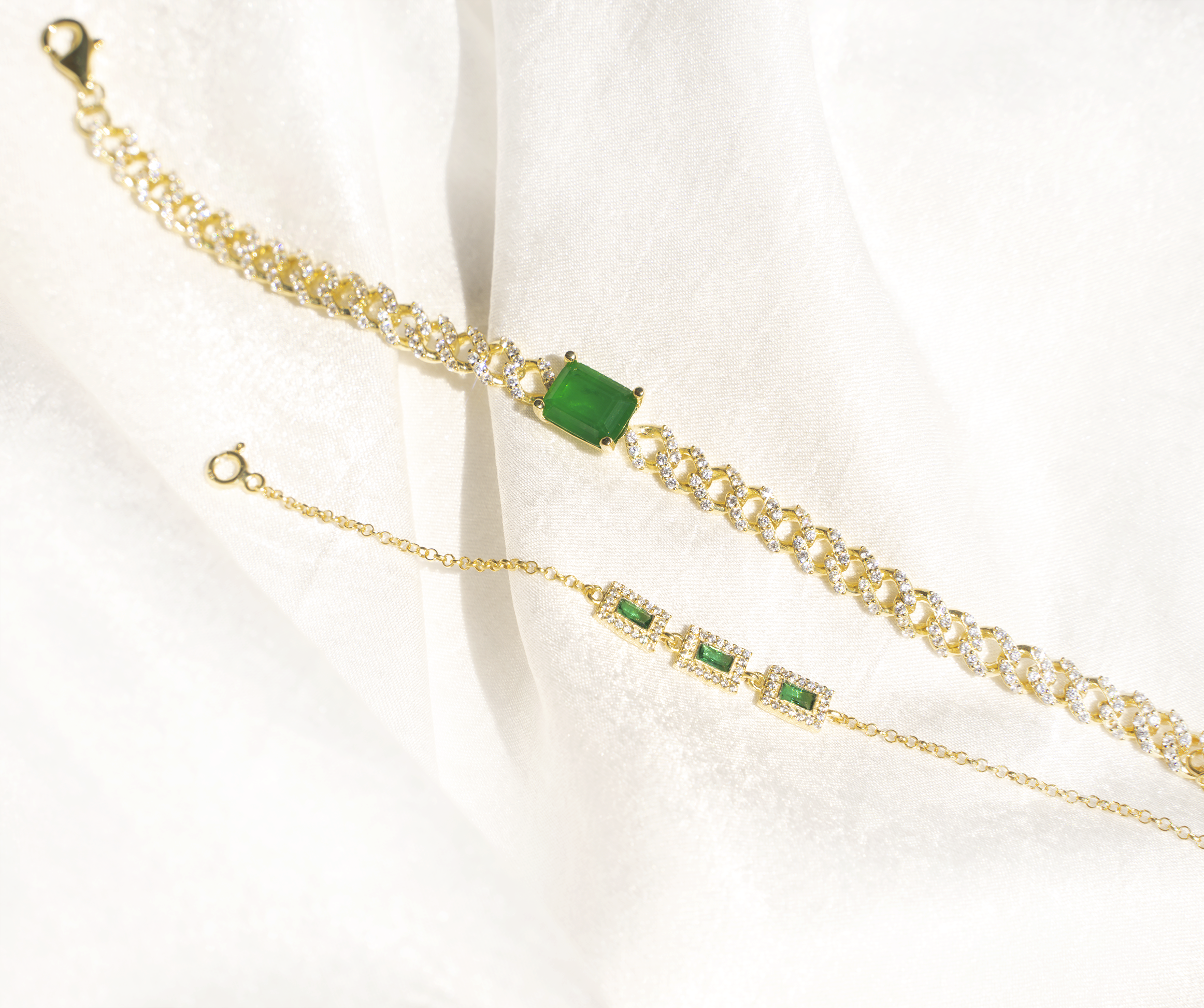 ALYA Bracelet featuring a chunky Miami curb chain with cubic zirconias and an emerald stone, elegantly designed in yellow gold plating.