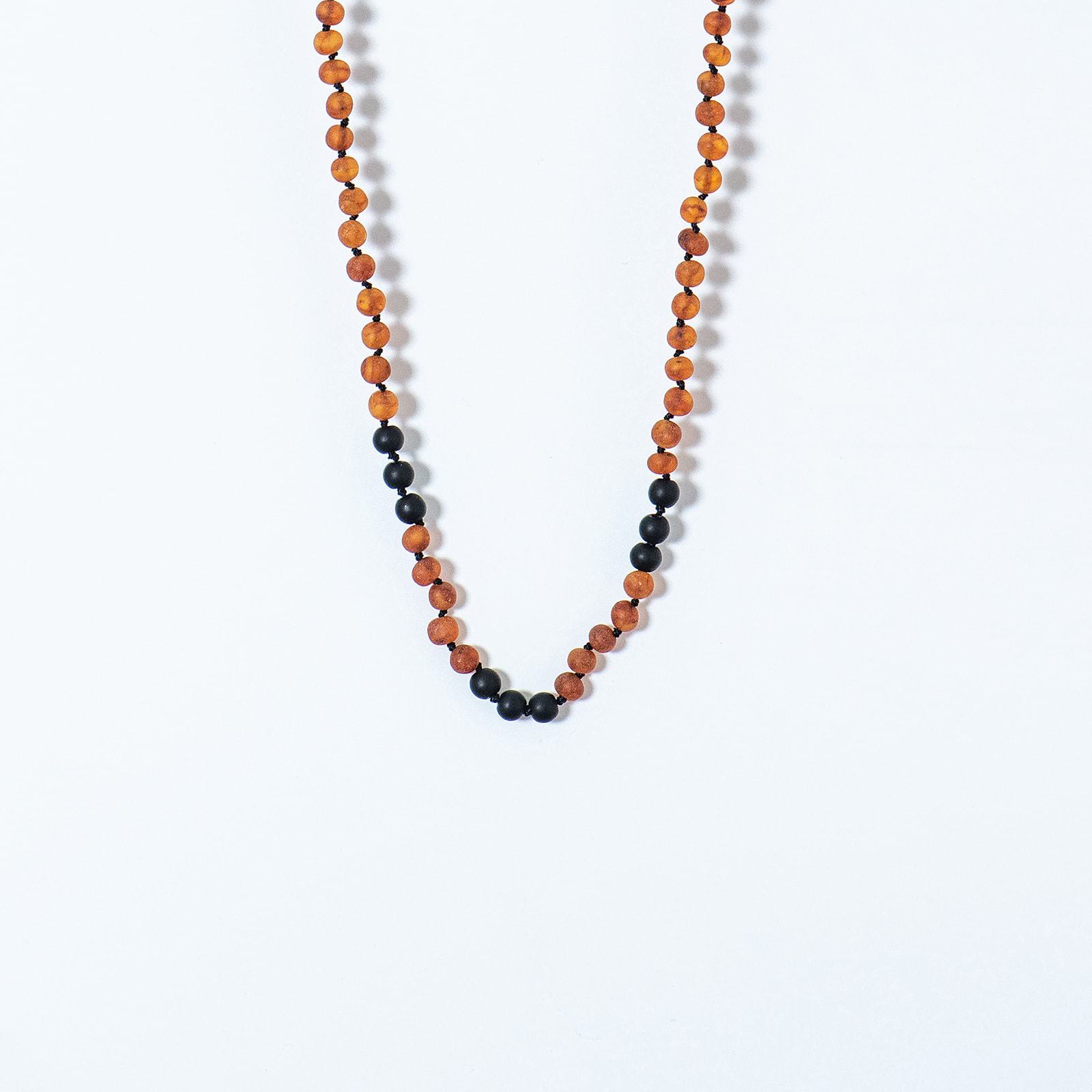 Amber and Shungite necklace designed for babies, featuring individually knotted beads for safety and natural radiation protection.