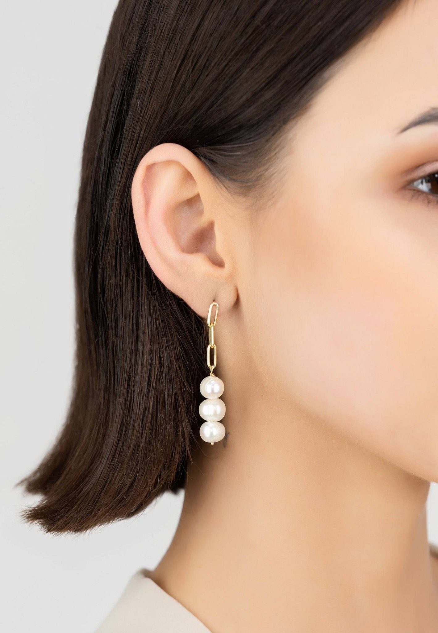 Amelia Three Pearl Drop Earrings in Gold featuring three white pearls on a delicate cable chain.