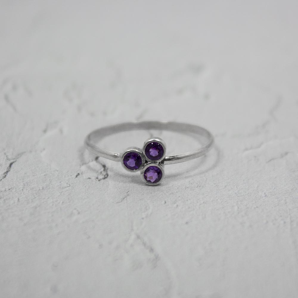 Amethyst Cluster Sterling Silver Ring featuring three round brilliant amethysts set in a tube formation on a delicate band.