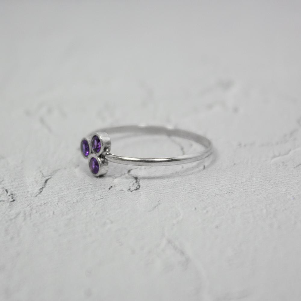 Amethyst Cluster Sterling Silver Ring featuring three round brilliant amethysts set in a tube formation on a delicate band.