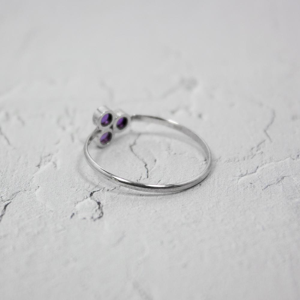 Amethyst Cluster Sterling Silver Ring featuring three round brilliant amethysts set in a tube formation on a delicate band.